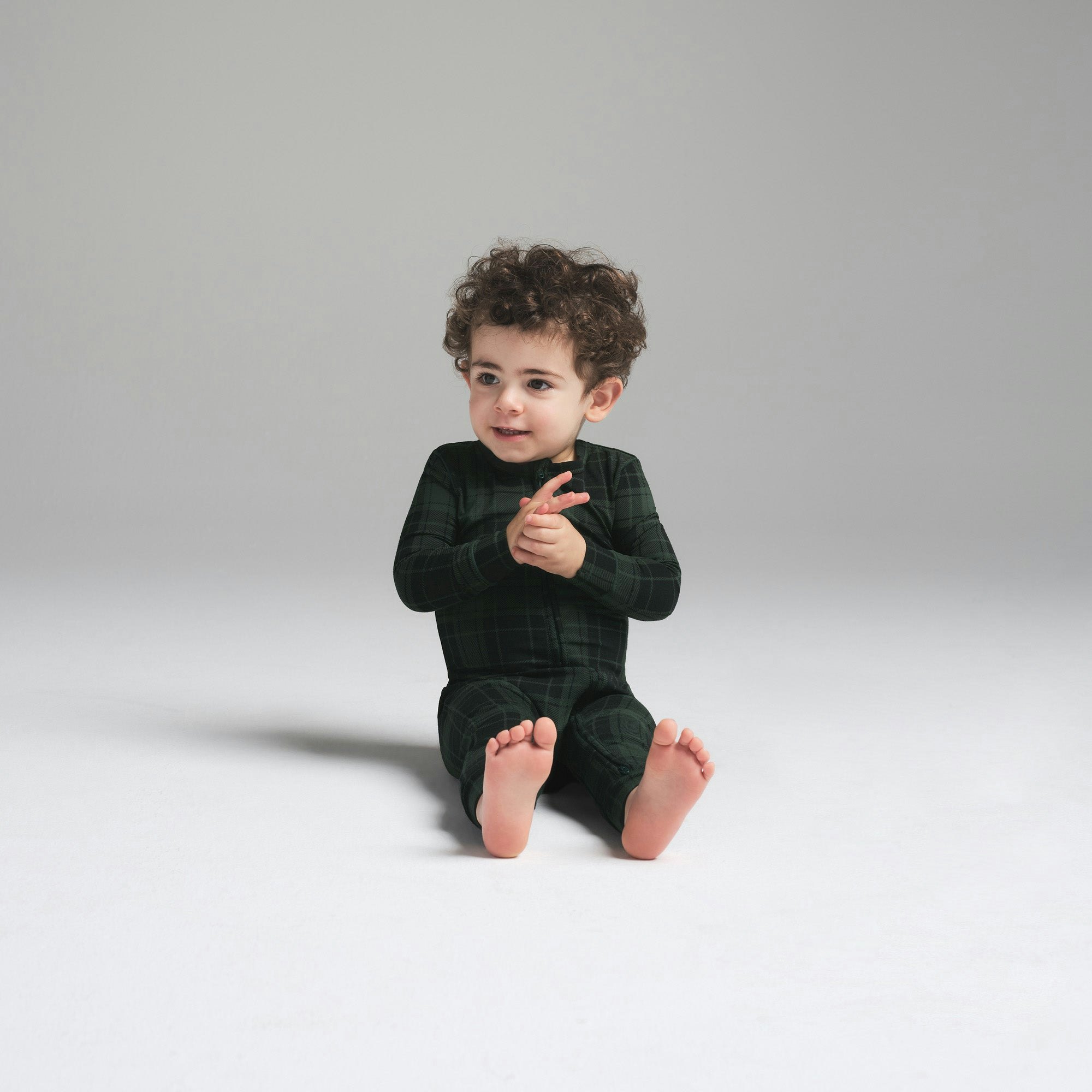 SKIMS SLEEP BABY ONESIE | CYPRESS PLAID ON A MODEL FRONT VIEW