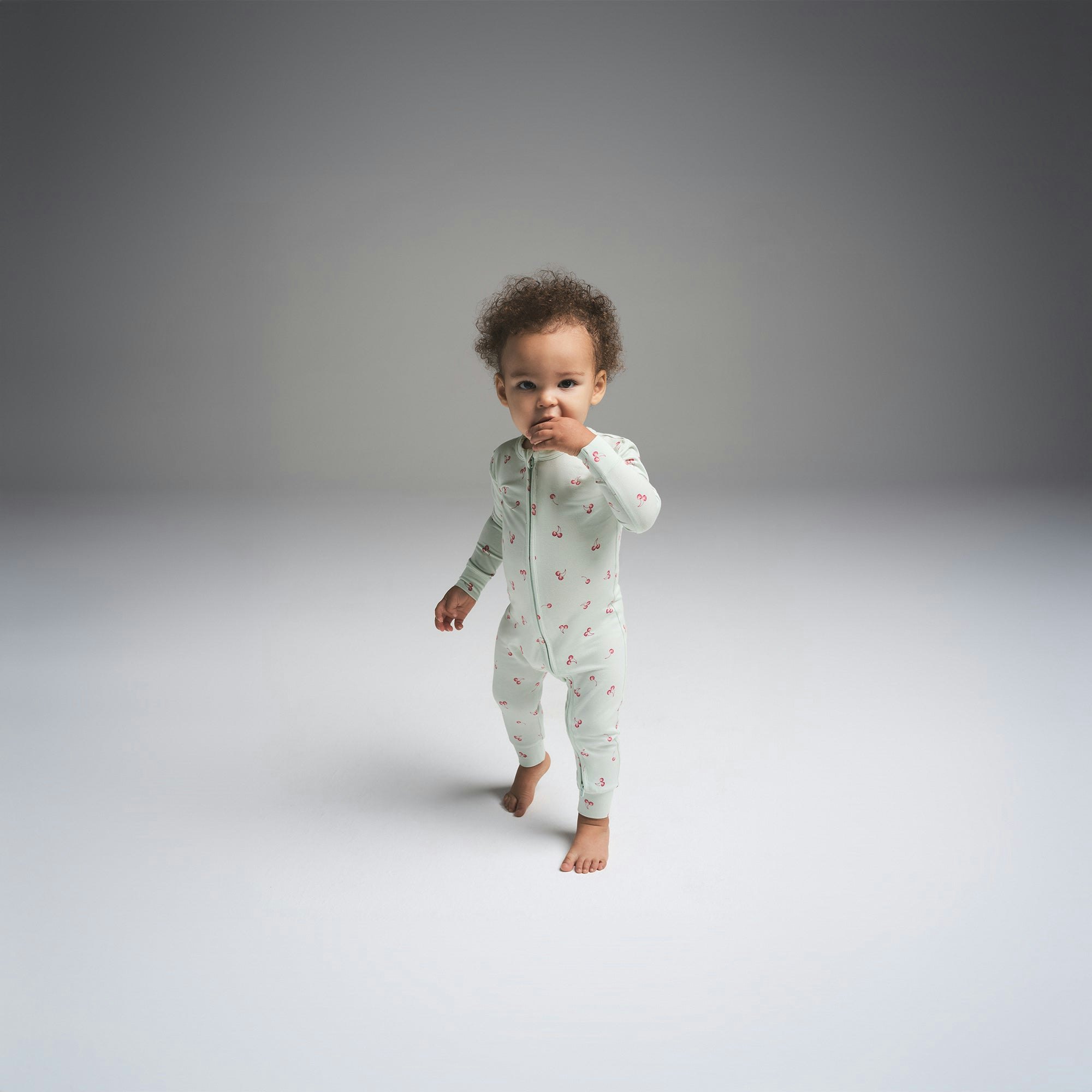 SKIMS SLEEP BABY ONESIE | CLOUD CHERRY PRINT ON A MODEL FRONT VIEW | FOCUS: 0.0, 1.0, 0.9