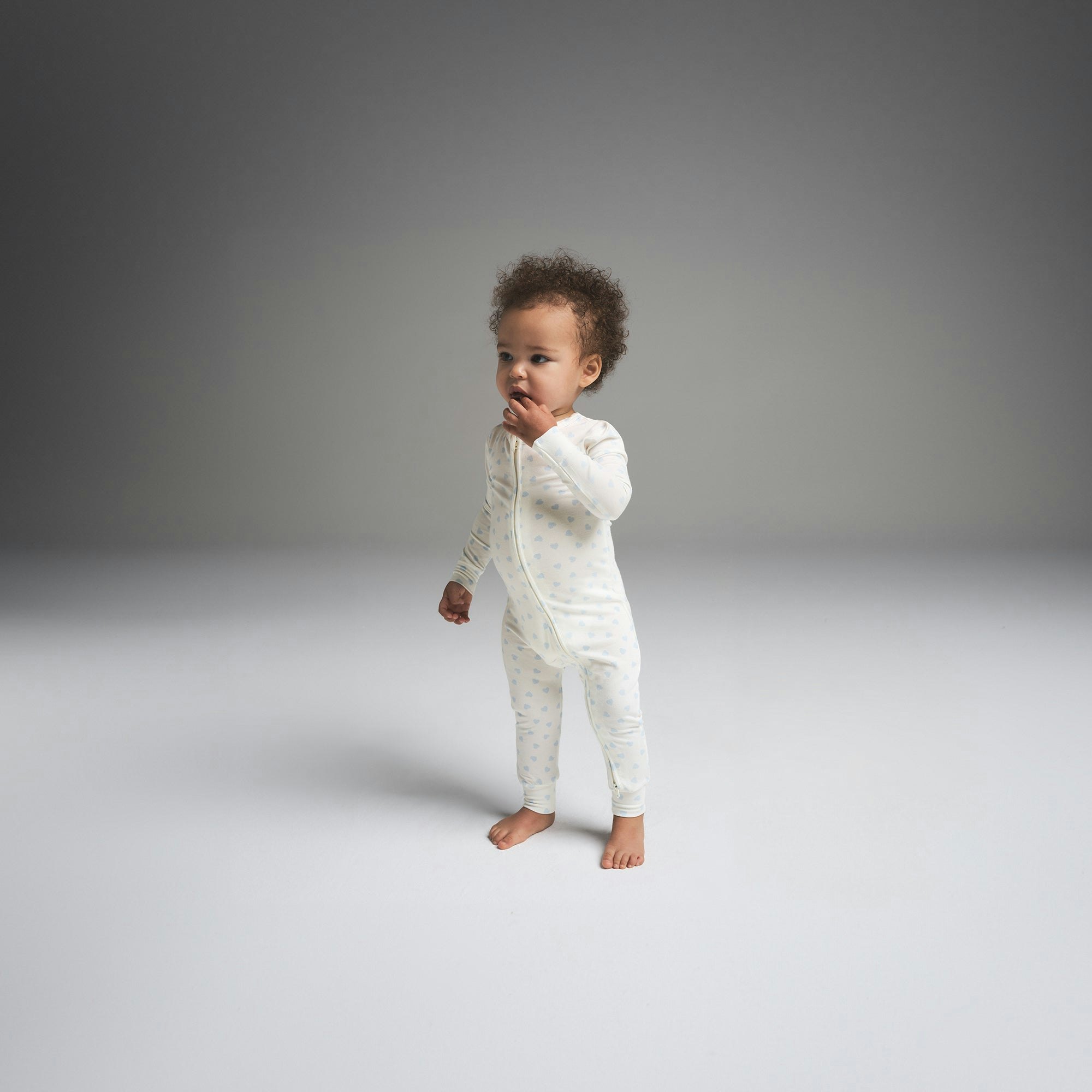 SKIMS SLEEP BABY ONESIE | MIRROR BALLOON PRINT ON A MODEL FRONT VIEW