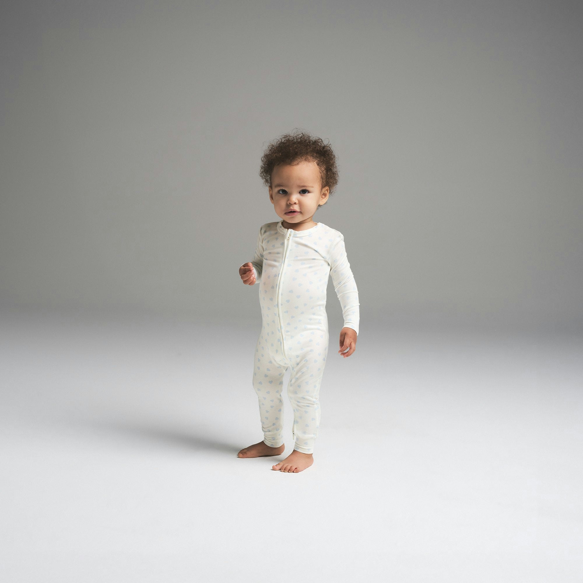 SKIMS SLEEP BABY ONESIE | MARBLE CLOUD HEART PRINT ON A MODEL FRONT VIEW | FOCUS: 0.0, 1.0, 0.9