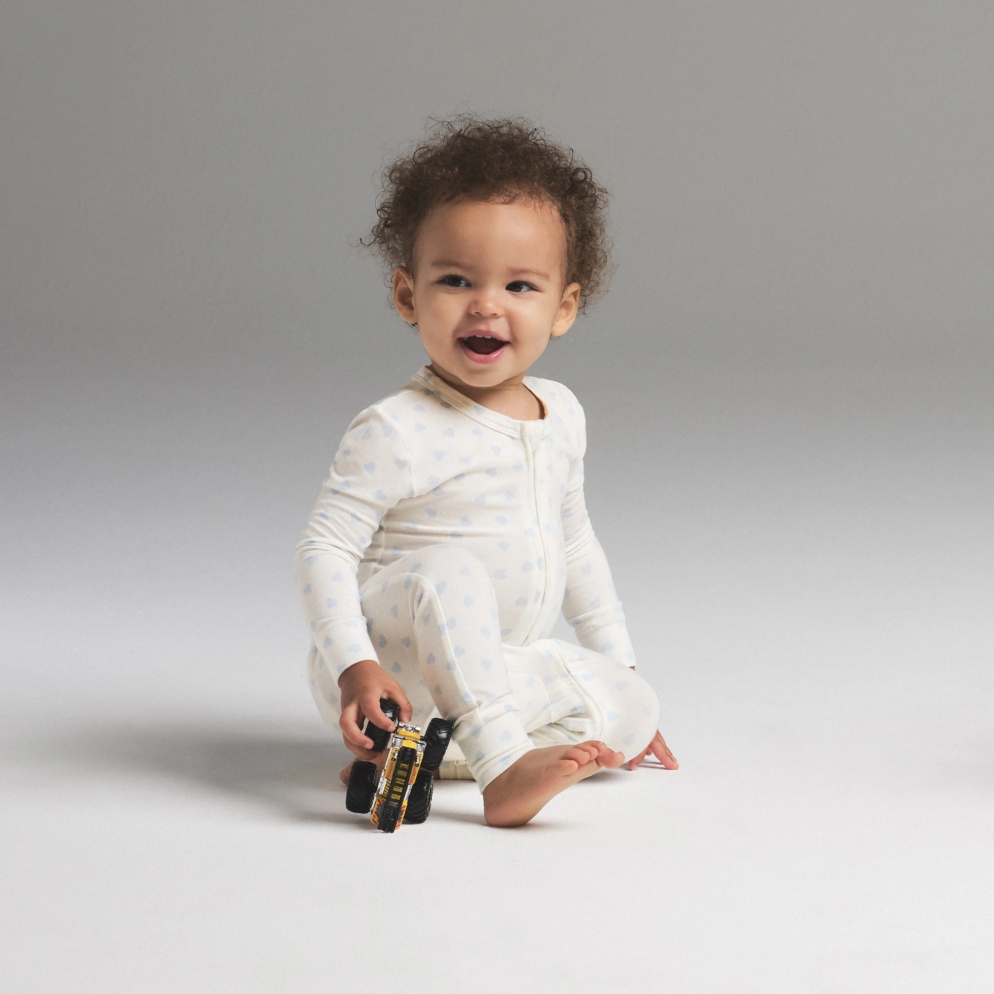 SKIMS SLEEP BABY ONESIE | MARBLE CLOUD HEART PRINT ON A MODEL SIDE VIEW | FOCUS: 0.0, 1.0, 0.9