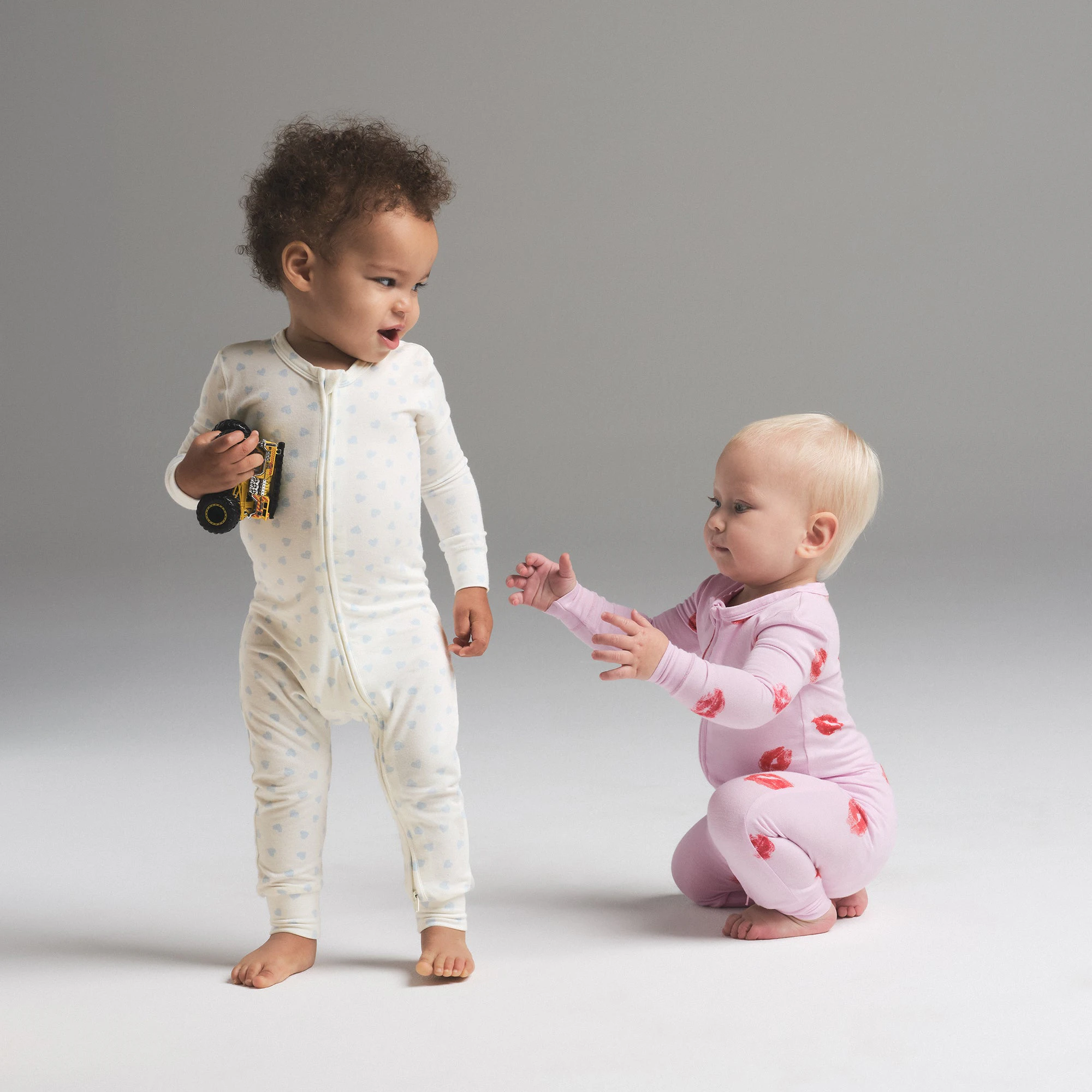 SKIMS SLEEP BABY ONESIE | MARBLE CLOUD HEART PRINT ON A MODEL SIDE VIEW | FOCUS: 0.0, 1.0, 0.9