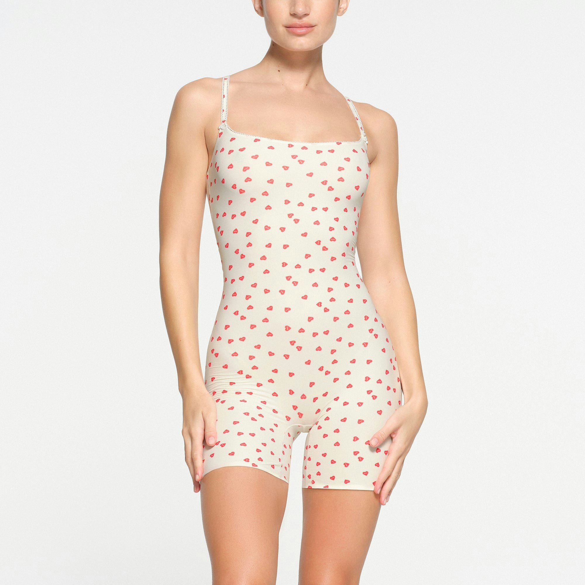 FITS EVERYBODY PICOT TRIM ONESIE | RUBY HEART PRINT ON A MODEL FRONT VIEW