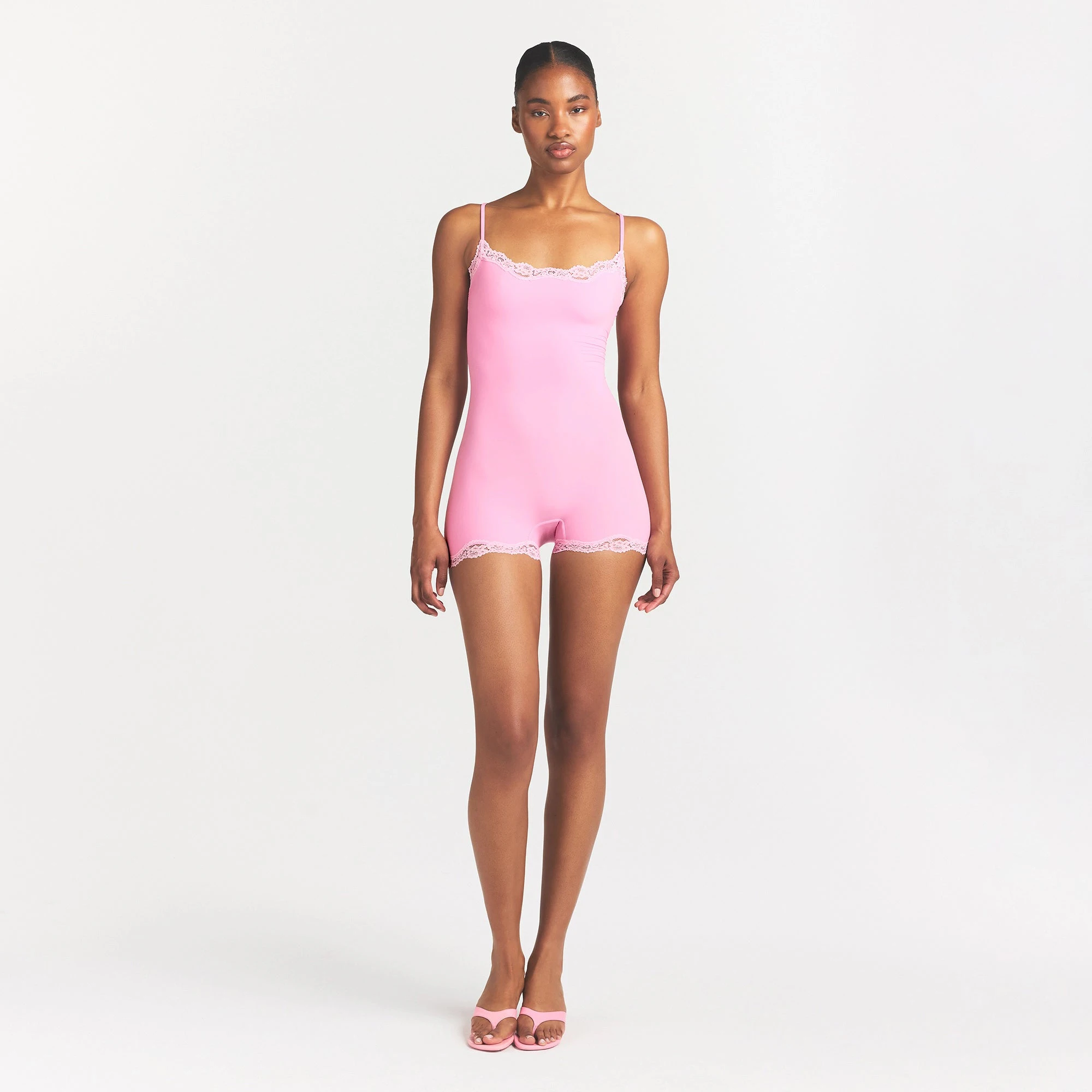 FITS EVERYBODY LACE ONESIE | BUBBLE GUM TONAL ON A MODEL FRONT VIEW @ | FOCUS: 0.0, 1.0, 0.9
