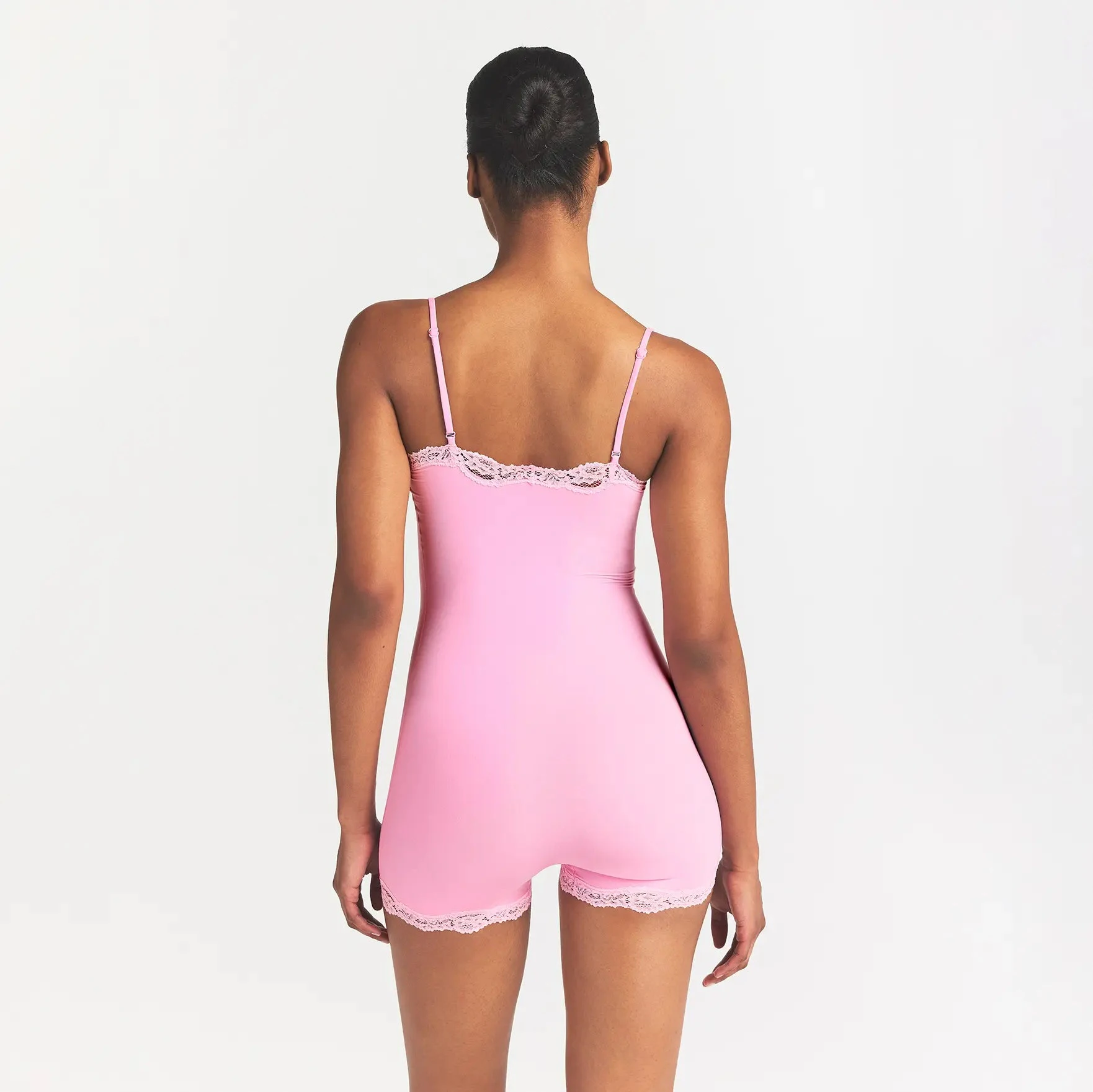 FITS EVERYBODY LACE ONESIE | BUBBLE GUM TONAL ON A MODEL BACK VIEW @ | FOCUS: 0.0, 1.0, 0.9