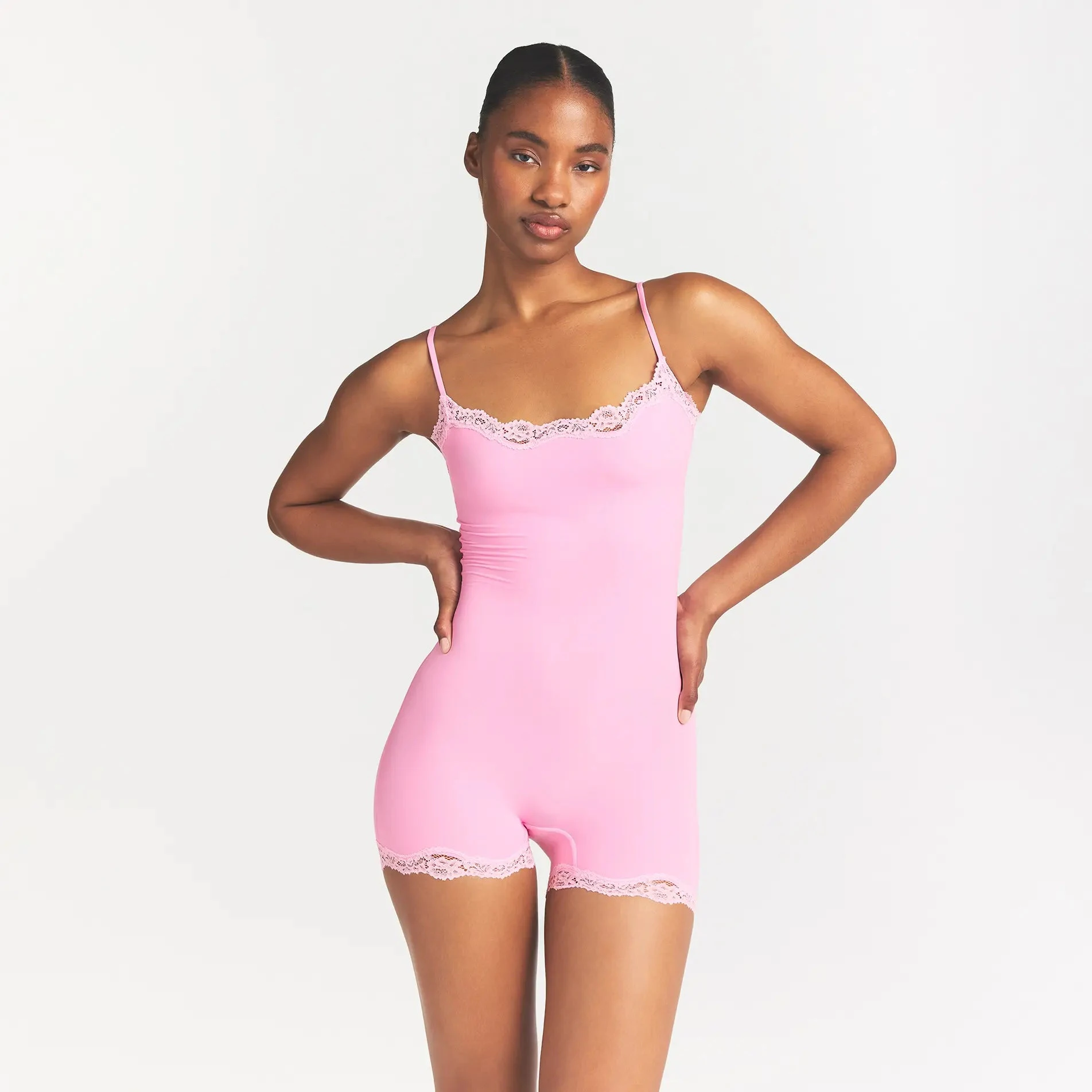 FITS EVERYBODY LACE ONESIE | BUBBLE GUM TONAL ON A MODEL FRONT VIEW @ | FOCUS: 0.0, 1.0, 0.9