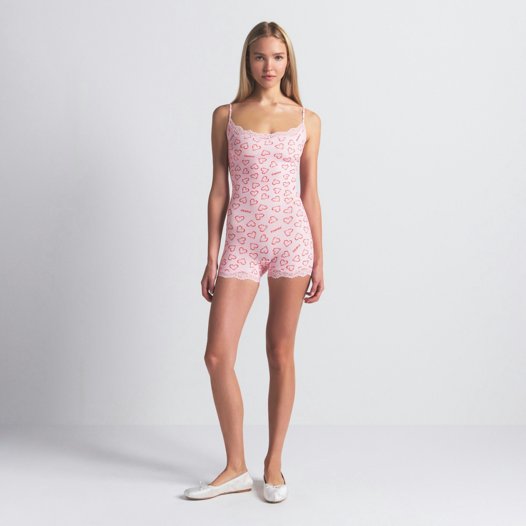 FITS EVERYBODY LACE ONESIE | CHERRY BLOSSOM CANDY HEART PRINT ON A MODEL FRONT VIEW @ | FOCUS: 0.0, 1.0, 0.9