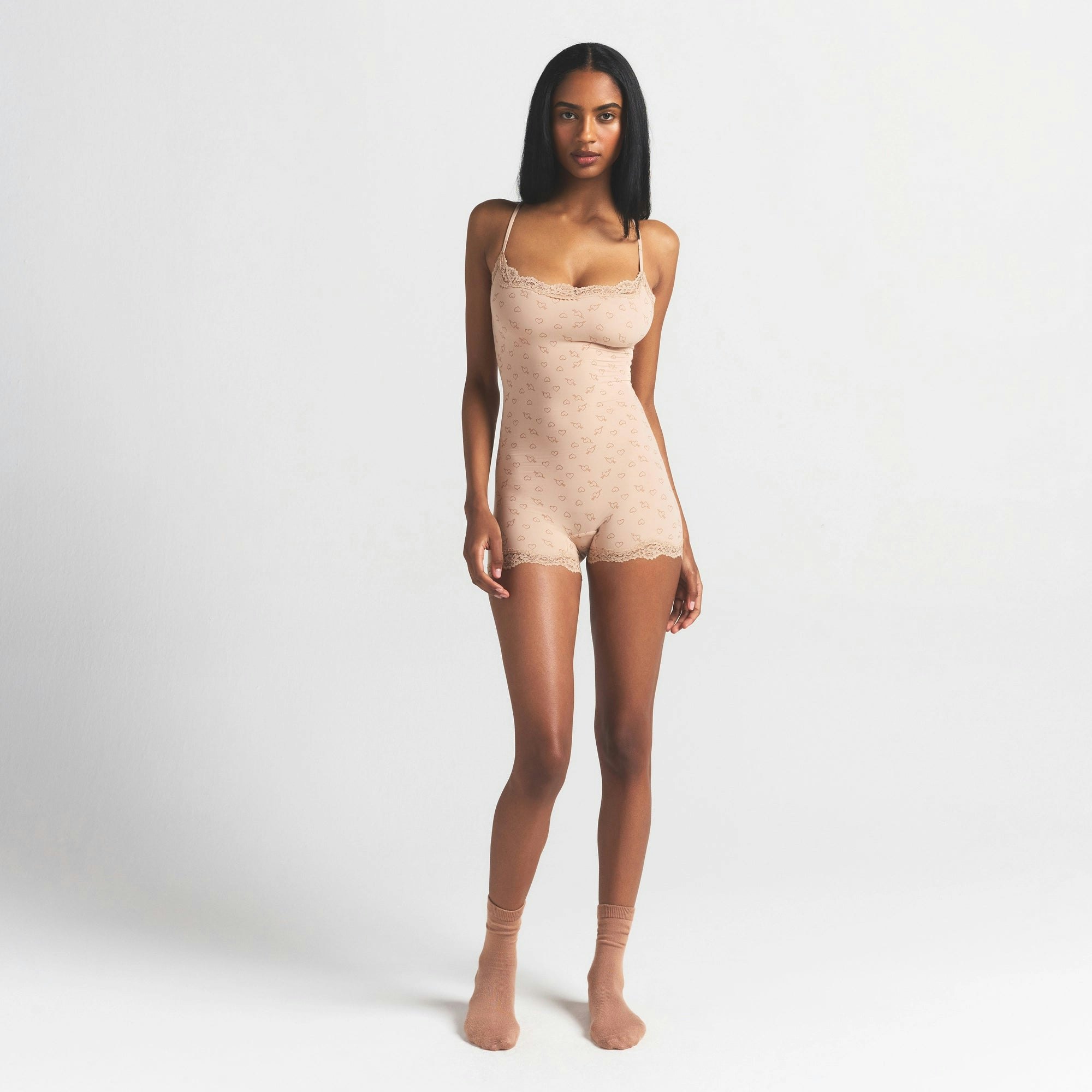 FITS EVERYBODY LACE ONESIE | MICA SKETCHED HEARTS ON A MODEL FRONT VIEW @ | FOCUS: 0.0, 1.0, 0.9