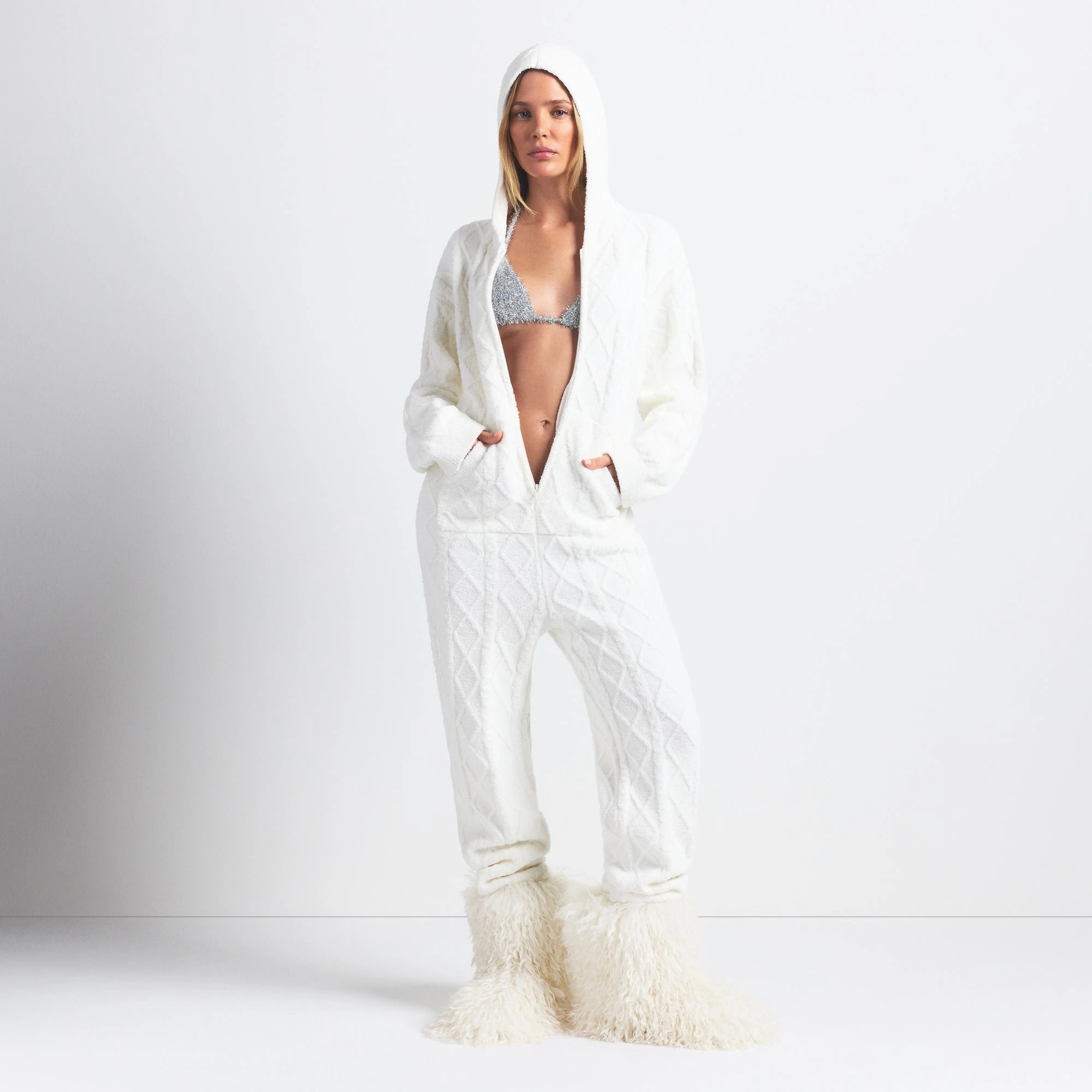 COZY LIGHT OVERSIZED CABLEKNIT ONESIE | IVORY ON A MODEL FRONT VIEW @ | FOCUS: 0.0, 1.0, 0.9