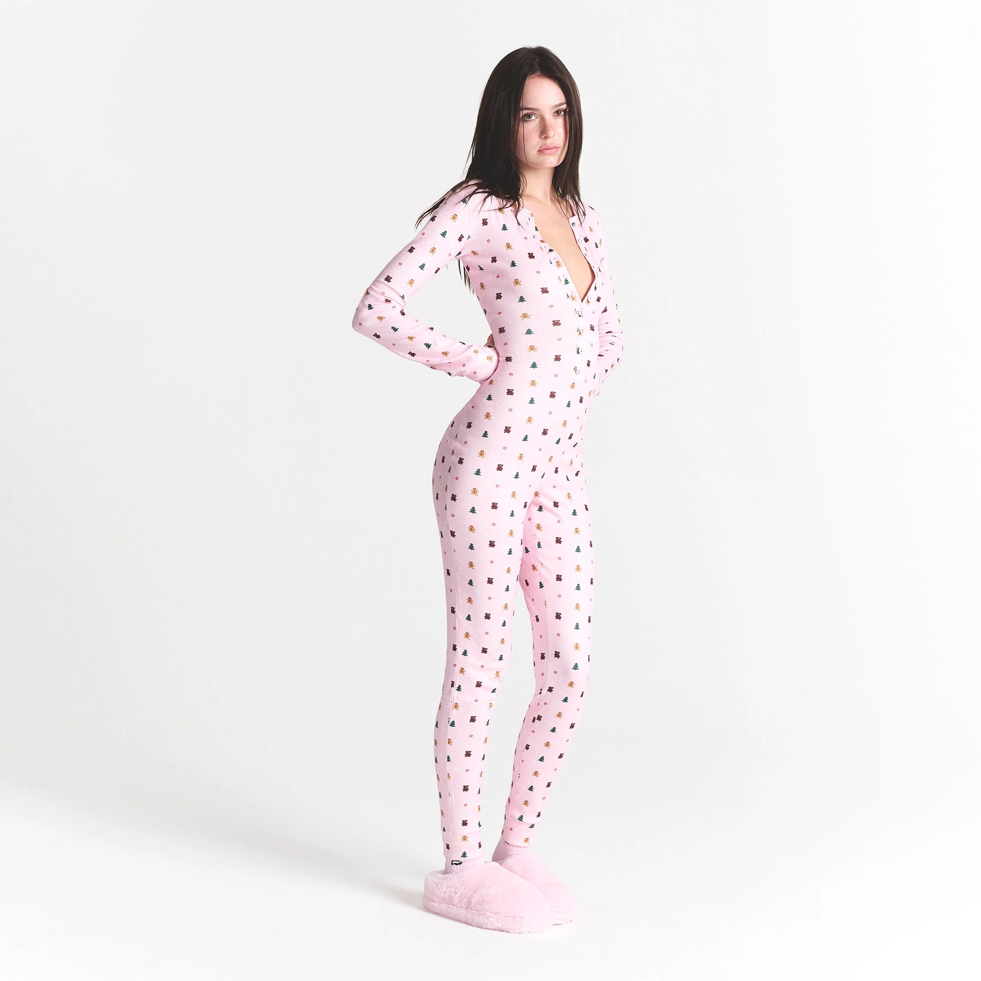 CACTUS PLANT FLEA MARKET X SKIMS PLUSH POINTELLE ONESIE | CHERRY BLOSSOM SNOW PRINT ON A MODEL SIDE VIEW @ | FOCUS: 0.0, 1.0, 0.9