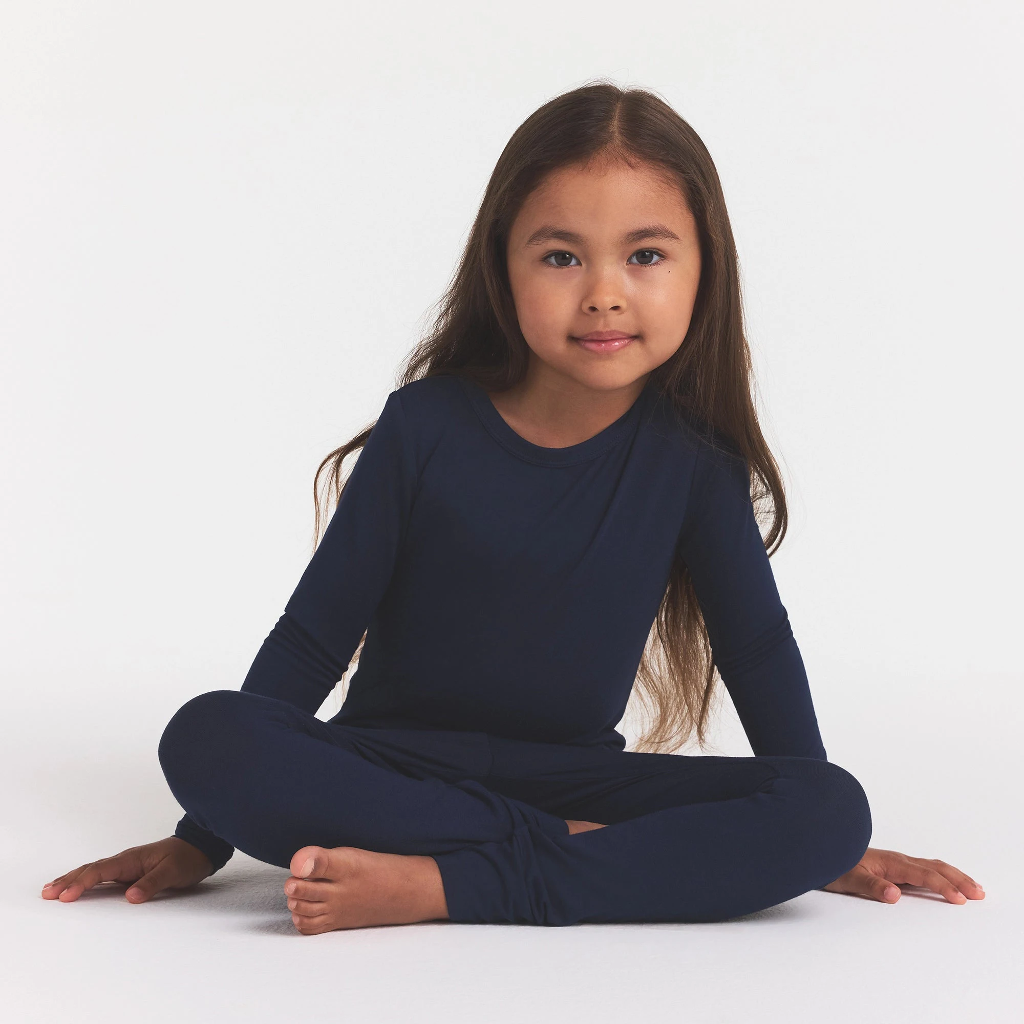 SKIMS SLEEP KIDS SLEEP SET | NAVY ON A MODEL FRONT VIEW @ | FOCUS: 0.0, 1.0, 0.9