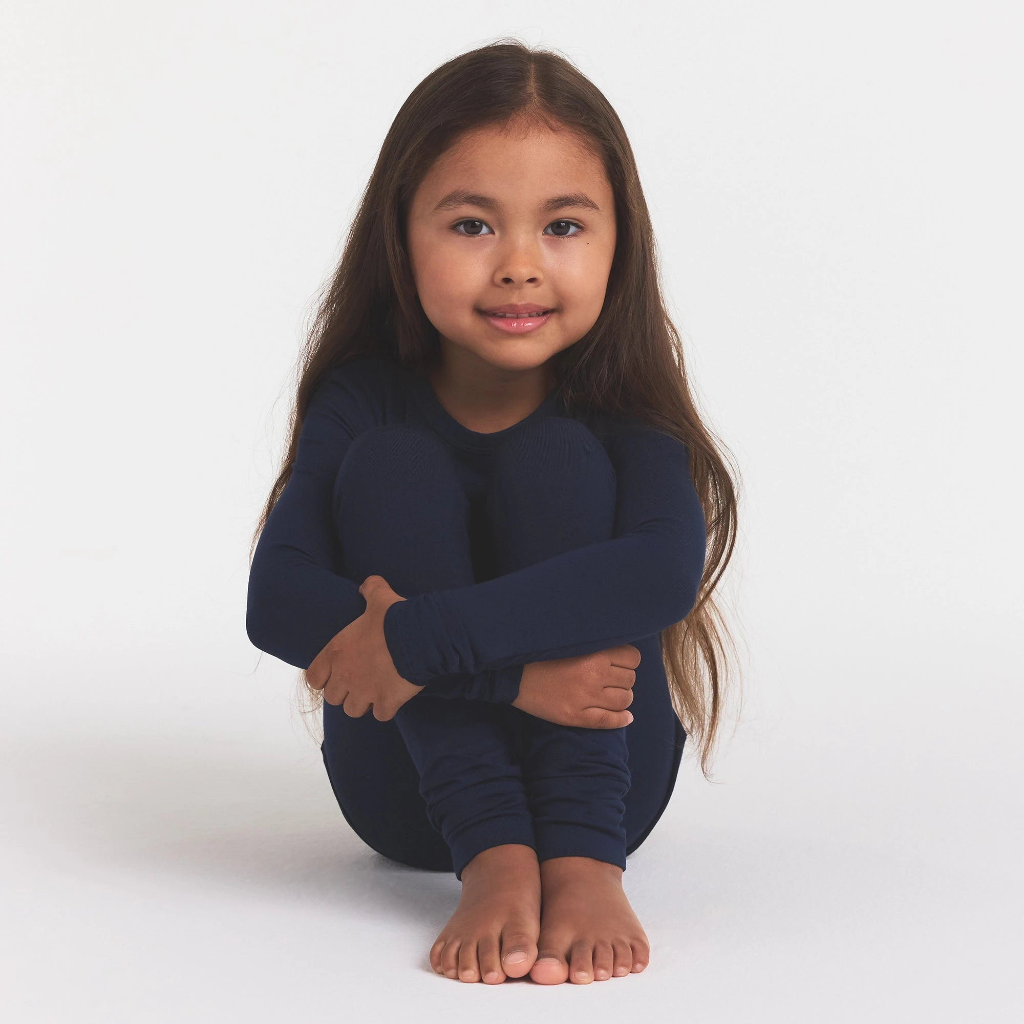 SKIMS SLEEP KIDS SLEEP SET | NAVY ON A MODEL FRONT VIEW @ | FOCUS: 0.0, 1.0, 0.9
