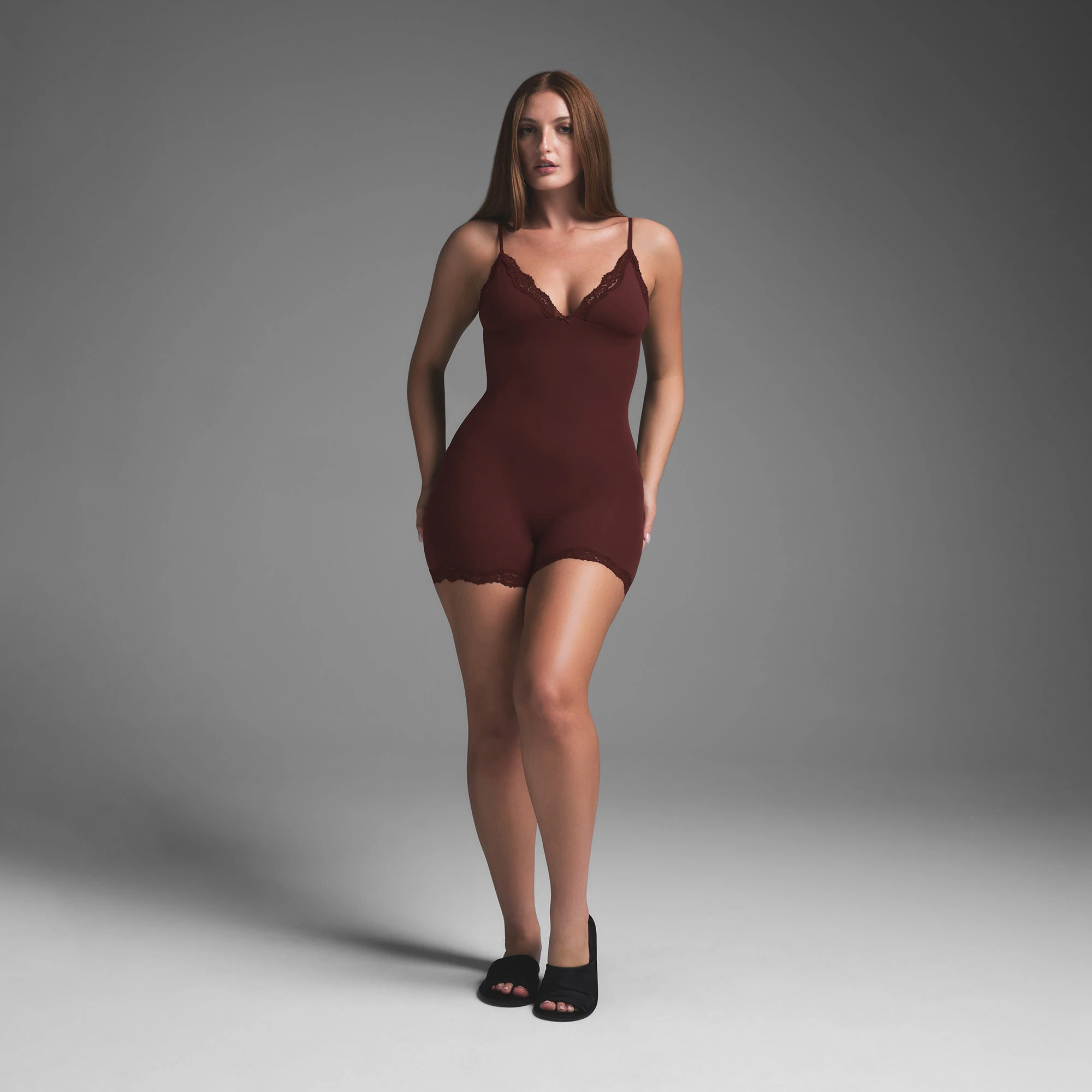 FITS EVERYBODY LACE TRIANGLE ONESIE | OXBLOOD ON A MODEL FRONT VIEW | FOCUS: 0.0, 1.0, 0.9