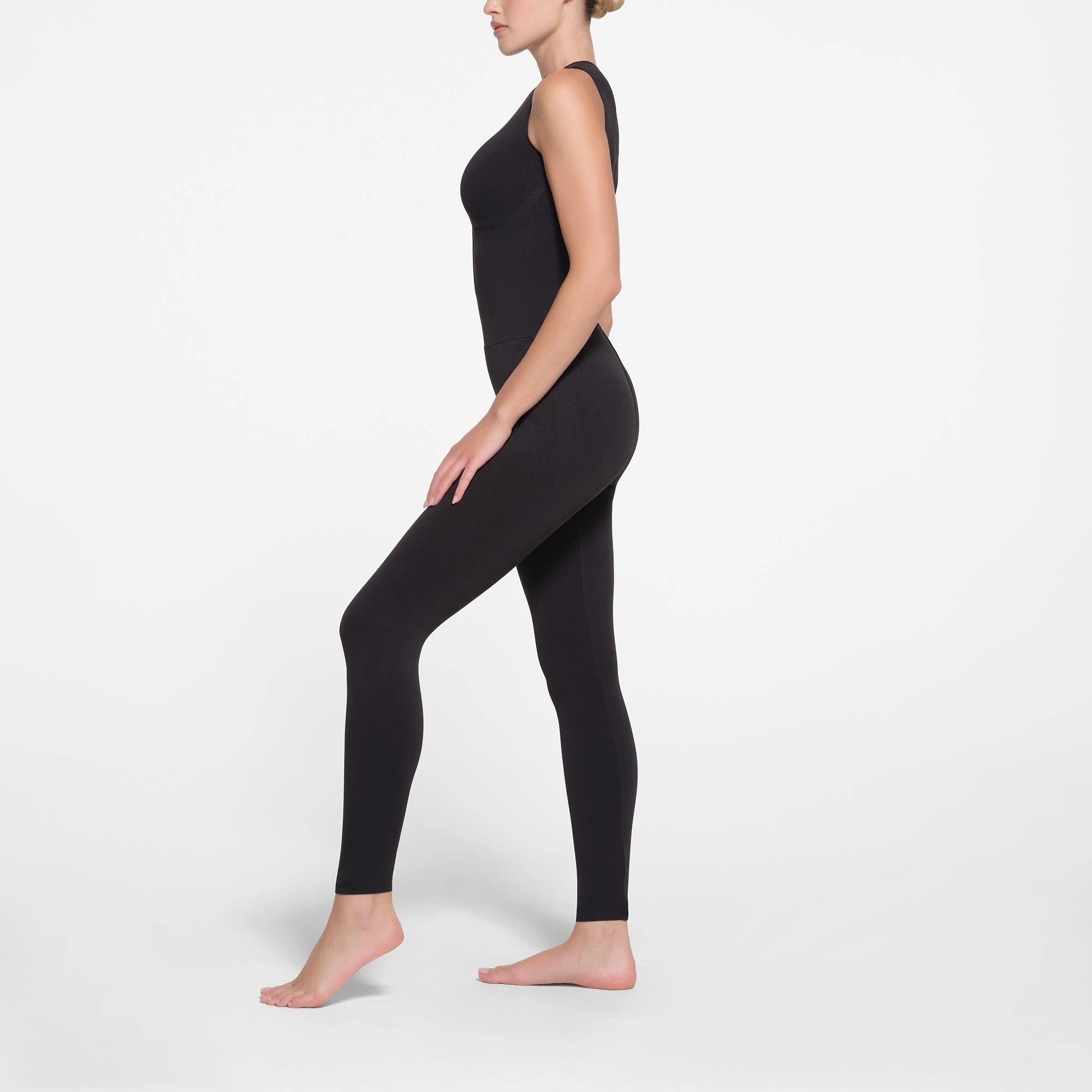 CONTOUR NYLON ZIP FRONT CATSUIT | ONYX ON A MODEL SIDE VIEW