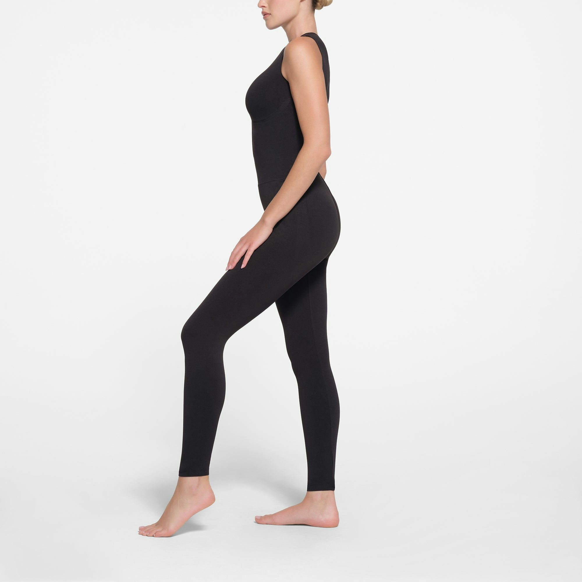 CONTOUR NYLON ZIP FRONT CATSUIT | ONYX ON A MODEL SIDE VIEW