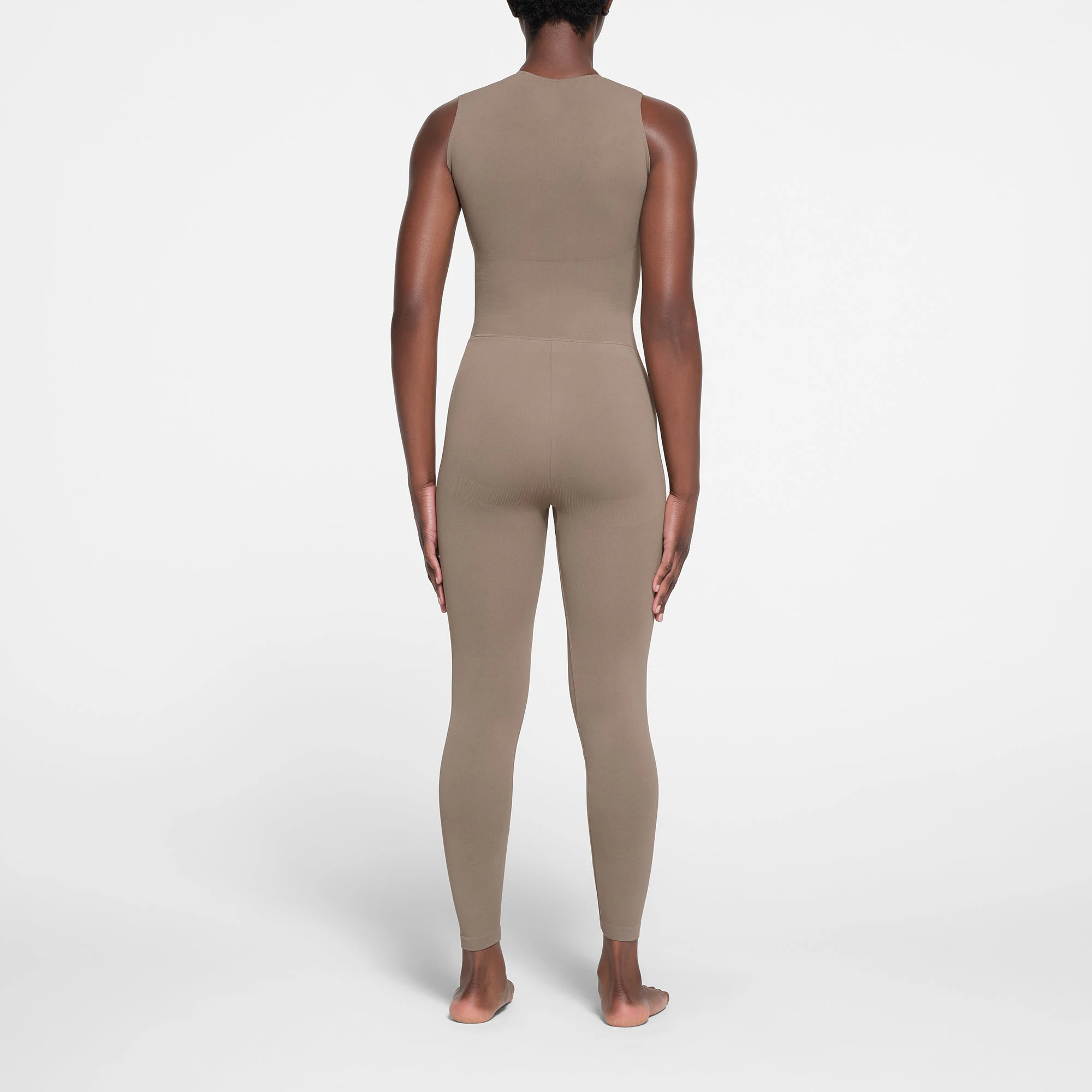 CONTOUR NYLON ZIP FRONT CATSUIT | TRUFFLE ON A MODEL BACK VIEW