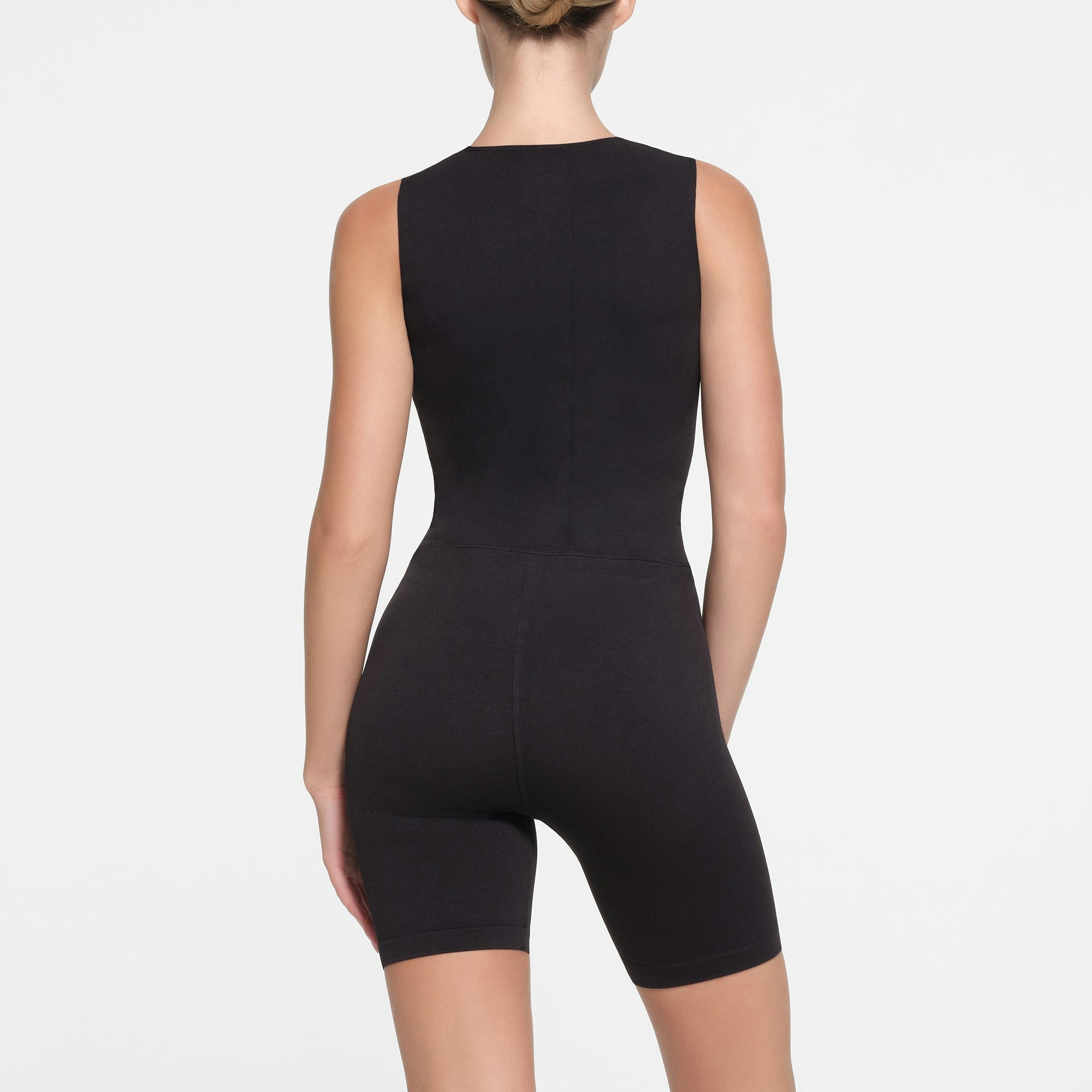 CONTOUR NYLON ZIP FRONT ONESIE | ONYX ON A MODEL BACK VIEW