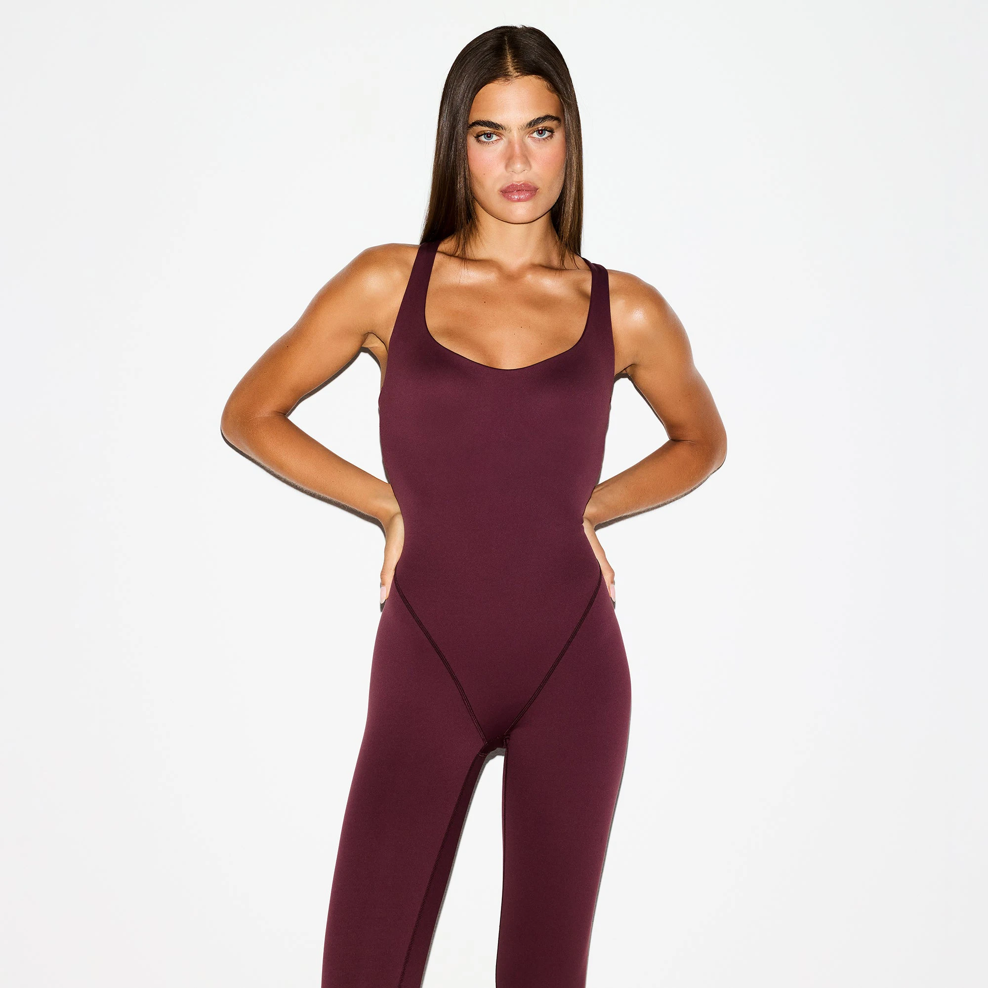 NikeSKIMS MATTE RACER LONG ONESIE | CURRANT ON A MODEL FRONT VIEW @ | FOCUS: 0.0, 1.0, 0.9
