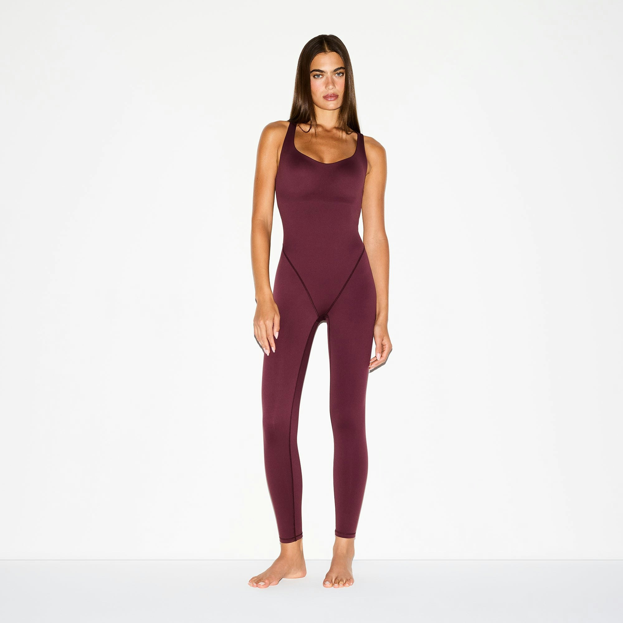 NikeSKIMS MATTE RACER LONG ONESIE | CURRANT ON A MODEL FRONT VIEW @ | FOCUS: 0.0, 1.0, 0.9