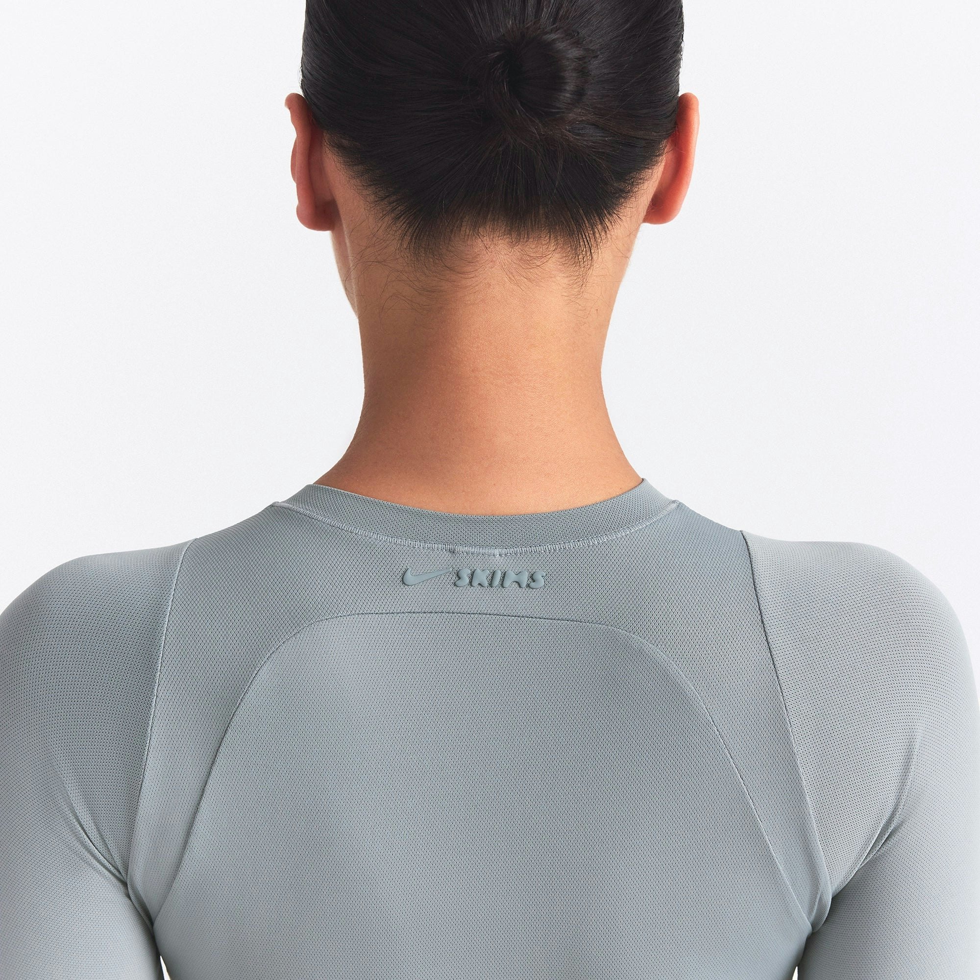 NikeSKIMS AIRY CREWNECK LONG SLEEVE ONE PIECE | WASHED PACIFIC ON A MODEL SIDE VIEW @ | FOCUS: 0.0, 1.0, 0.9