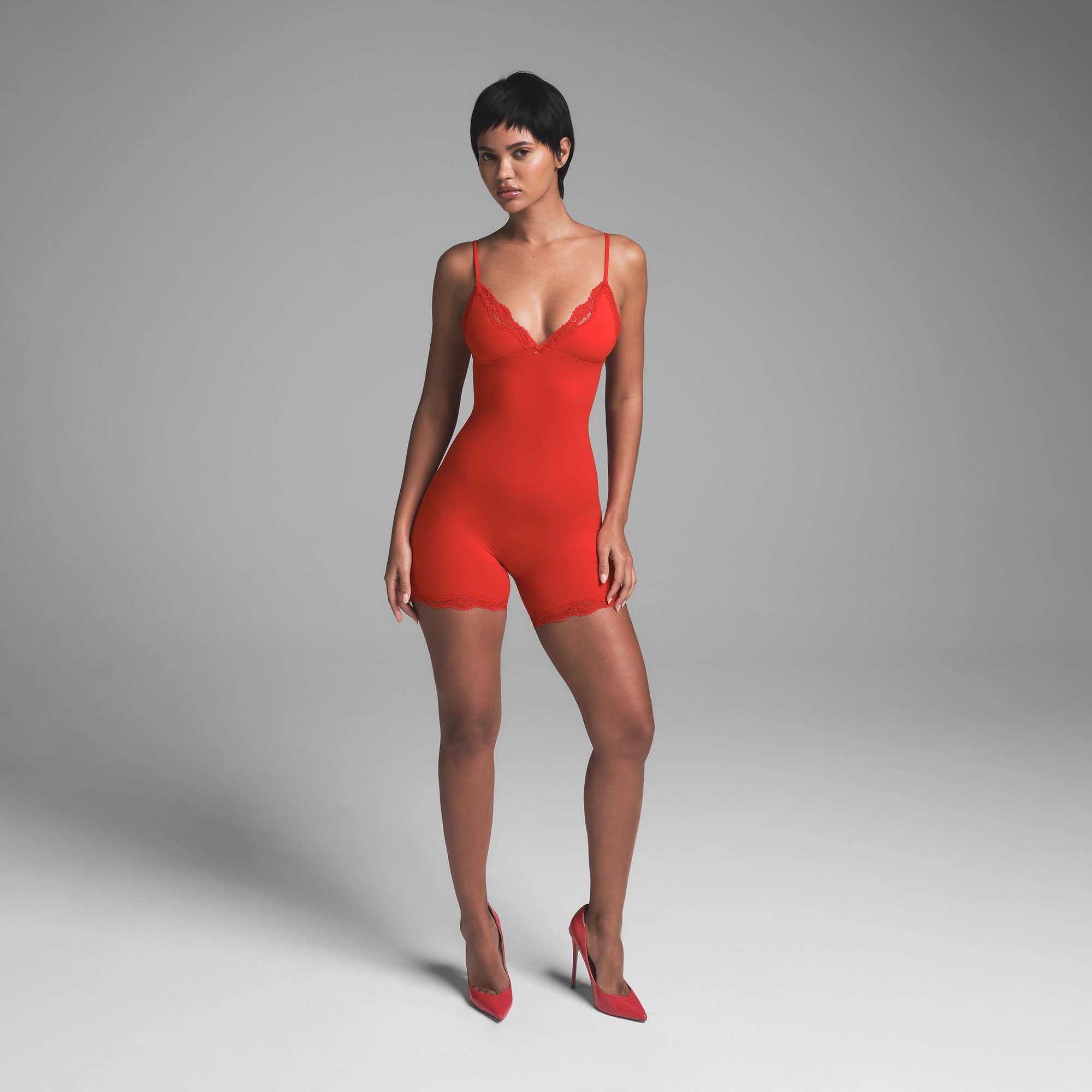 FITS EVERYBODY LACE TRIANGLE ONESIE | CAYENNE ON A MODEL FRONT VIEW | FOCUS: 0.0, 1.0, 0.9