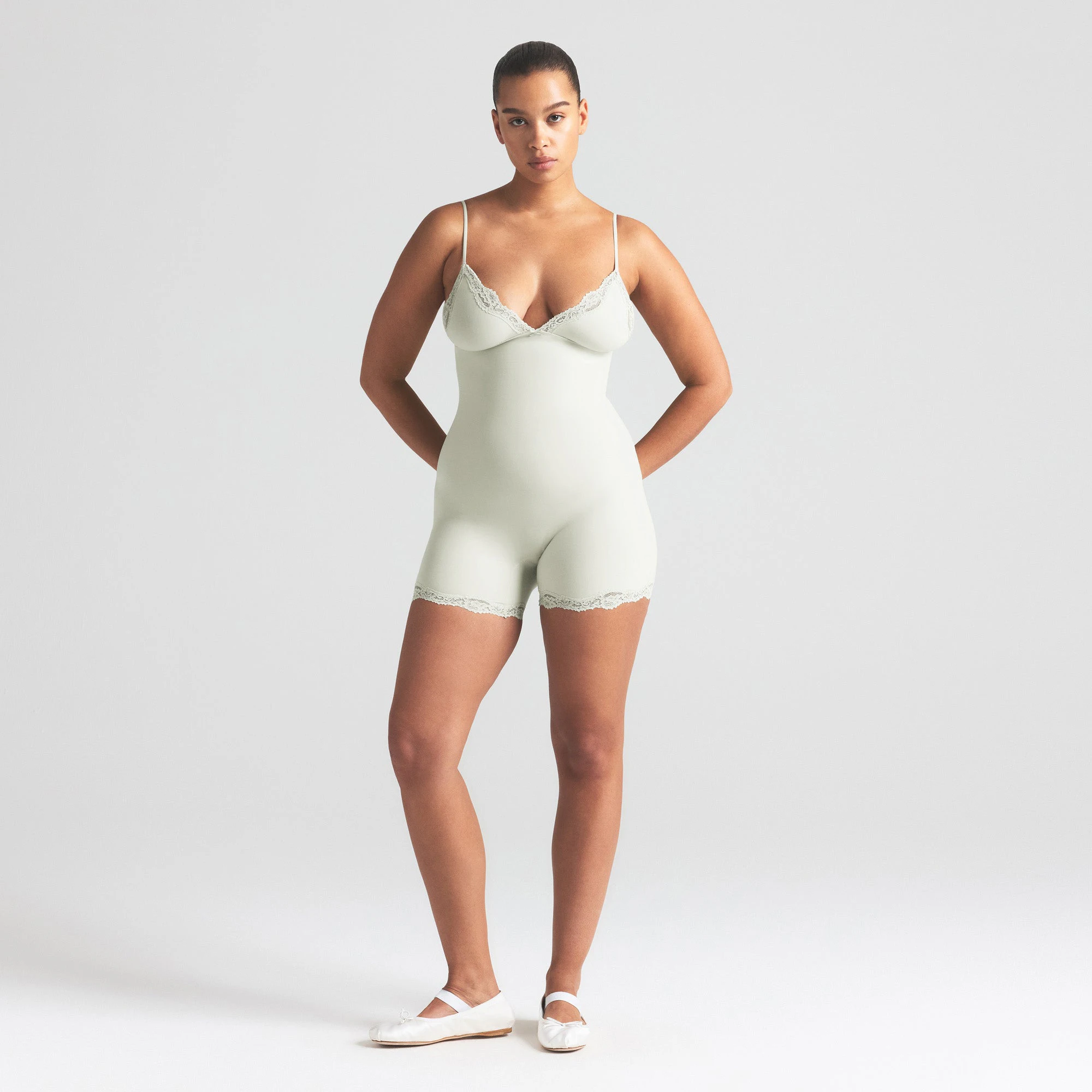 FITS EVERYBODY LACE TRIANGLE ONESIE | SPEARMINT ON A MODEL FRONT VIEW | FOCUS: 0.0, 1.0, 0.9