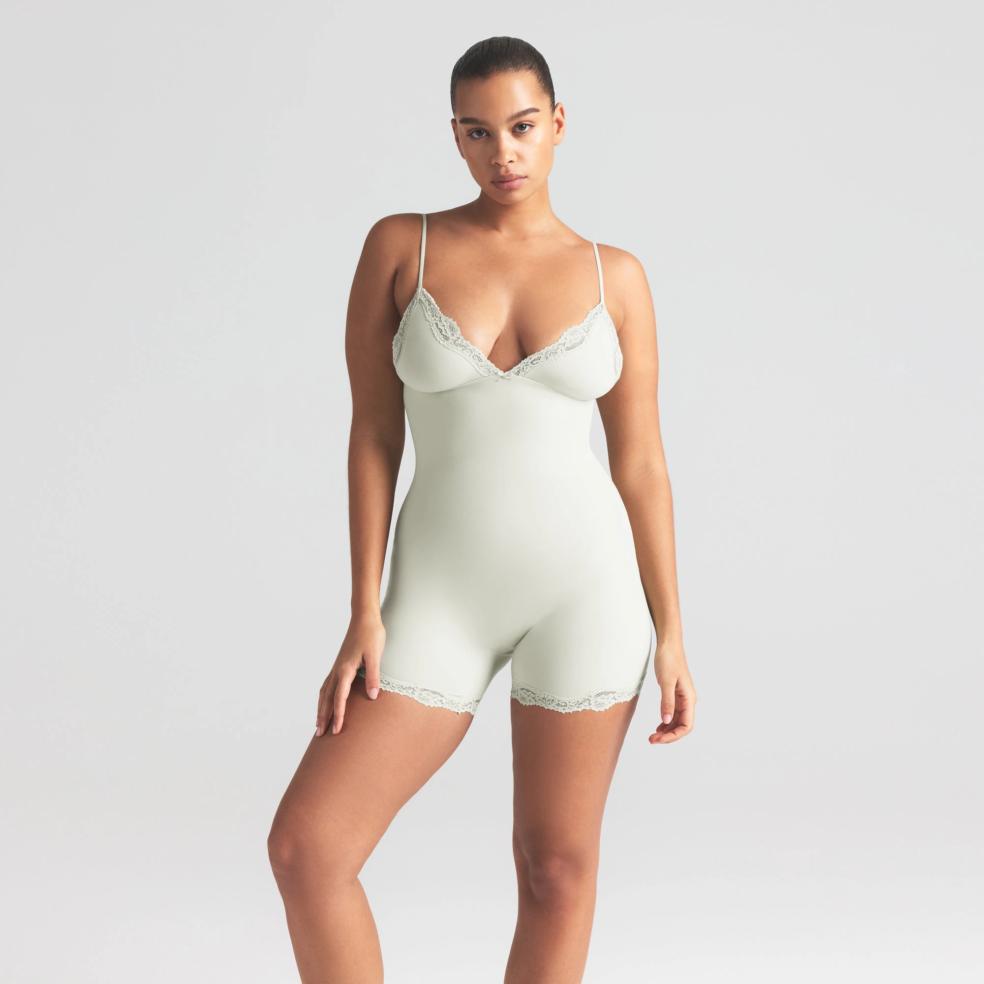 FITS EVERYBODY LACE TRIANGLE ONESIE | SPEARMINT ON A MODEL SIDE VIEW | FOCUS: 0.0, 1.0, 0.9