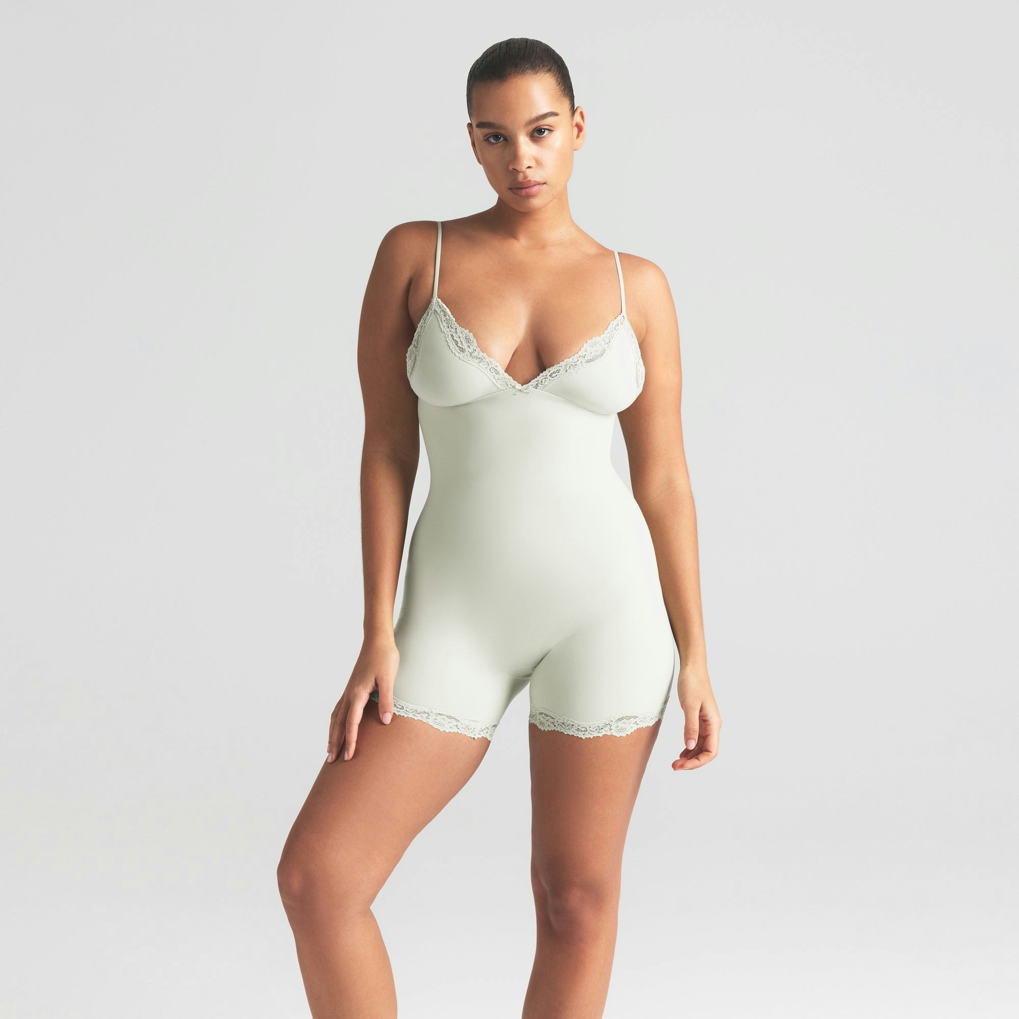 FITS EVERYBODY LACE TRIANGLE ONESIE | SPEARMINT ON A MODEL SIDE VIEW | FOCUS: 0.0, 1.0, 0.9