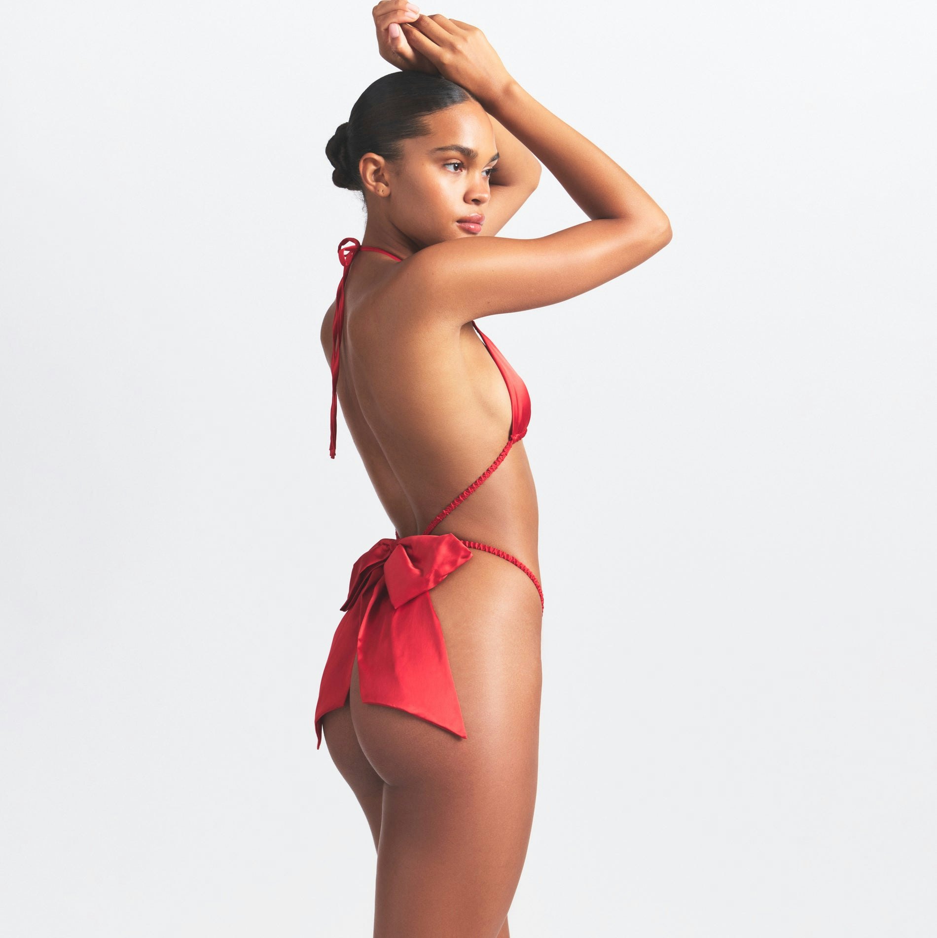 WOVEN SHINE SKIMPY BOW TEDDY | RED ON A MODEL SIDE VIEW @ | FOCUS: 0.0, 1.0, 0.9