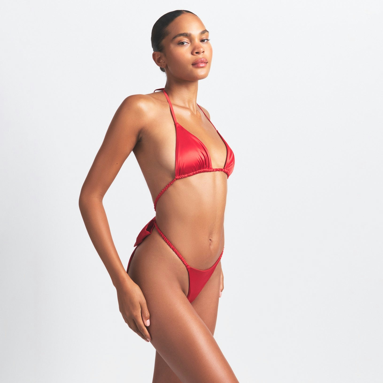 WOVEN SHINE SKIMPY BOW TEDDY | RED ON A MODEL SIDE VIEW @ | FOCUS: 0.0, 1.0, 0.9