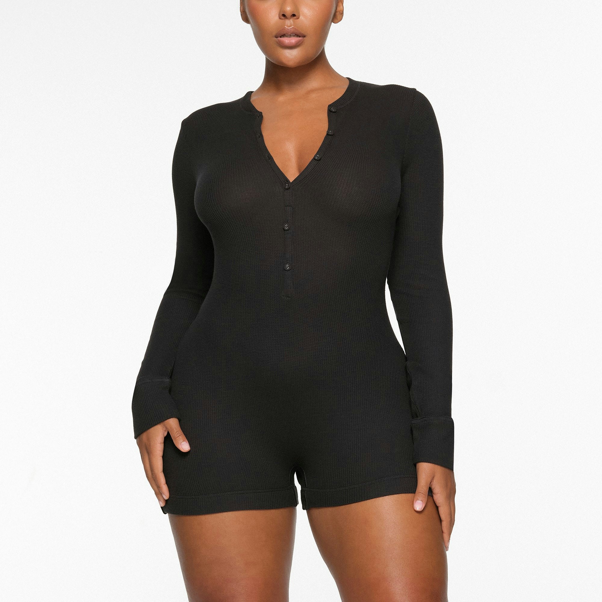 WAFFLE BUTTON UP HENLEY ONESIE WORN BY A MODEL IN FRONT VIEW