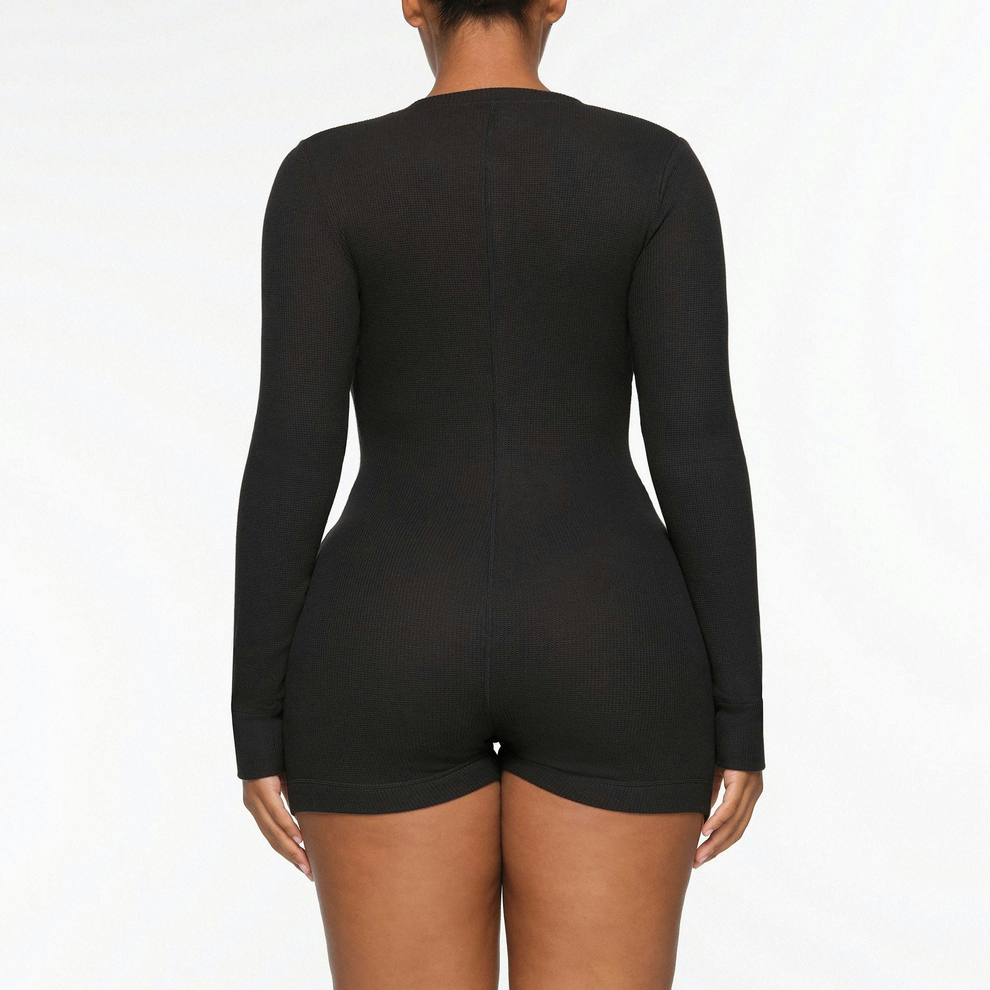 WAFFLE BUTTON UP HENLEY ONESIE WORN BY A MODEL IN BACK VIEW