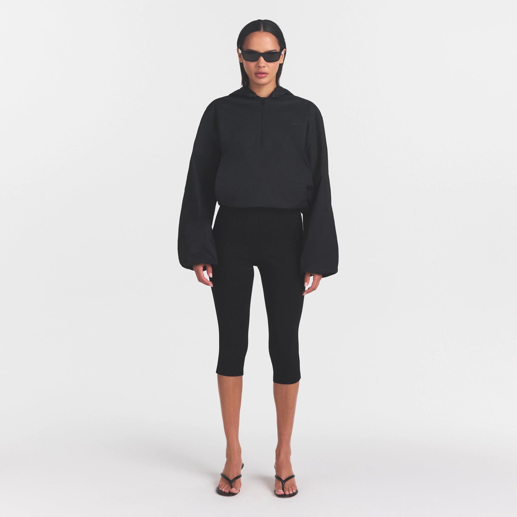 WOVEN COTTON HALF ZIP PULLOVER | ONYX ON A MODEL FRONT VIEW
