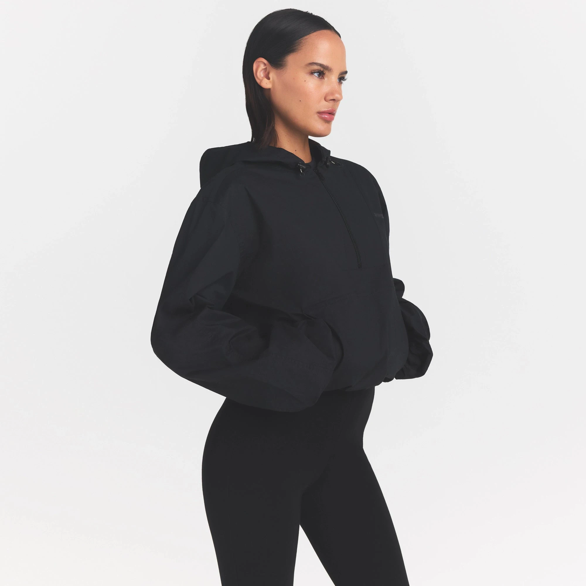WOVEN COTTON HALF ZIP PULLOVER | ONYX ON A MODEL SIDE VIEW