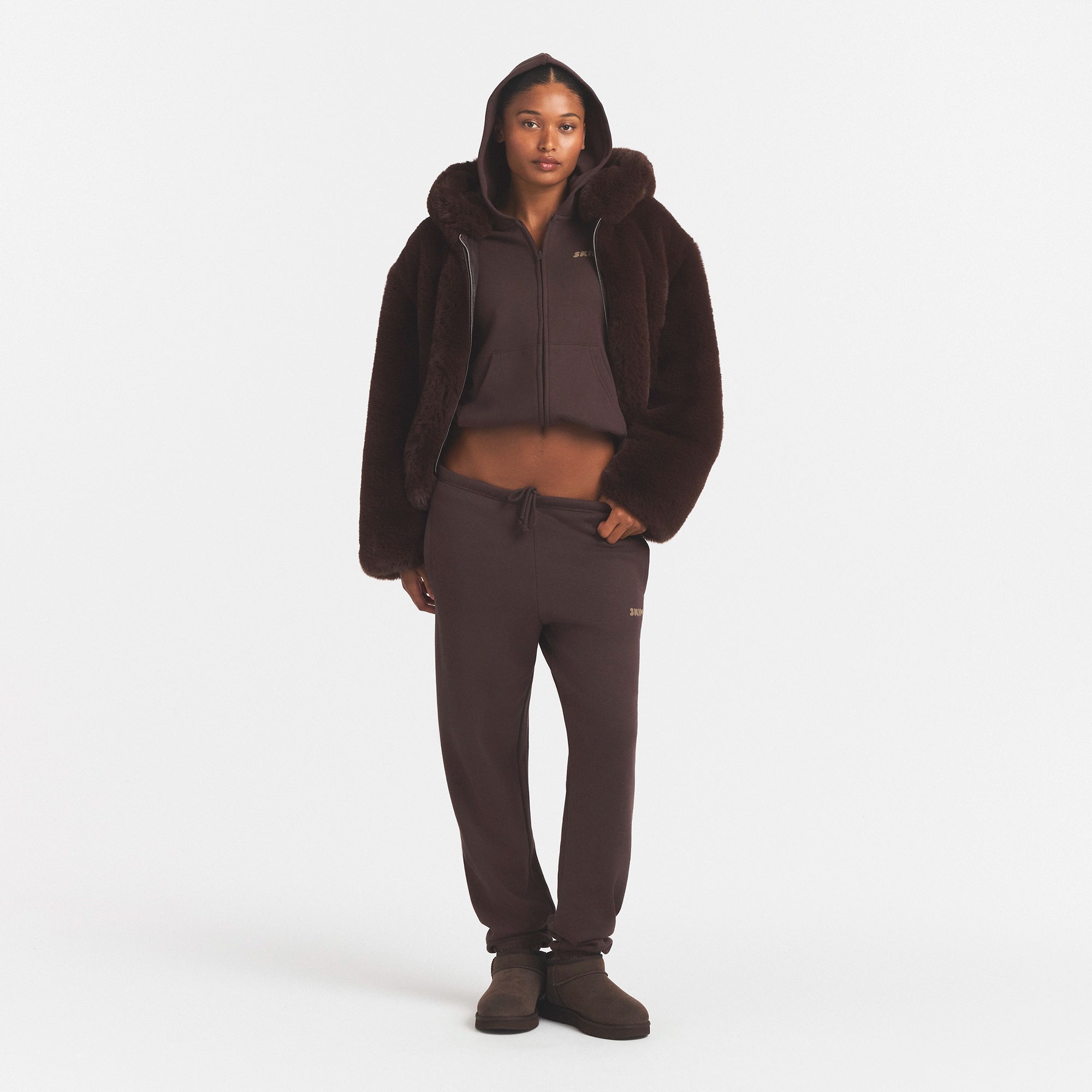 FAUX FUR HOODED JACKET | COCOA & LAYS FLAT ON A WHITE BACKGROUND | FLT @ | FOCUS: 0.0, 1.0, 0.9