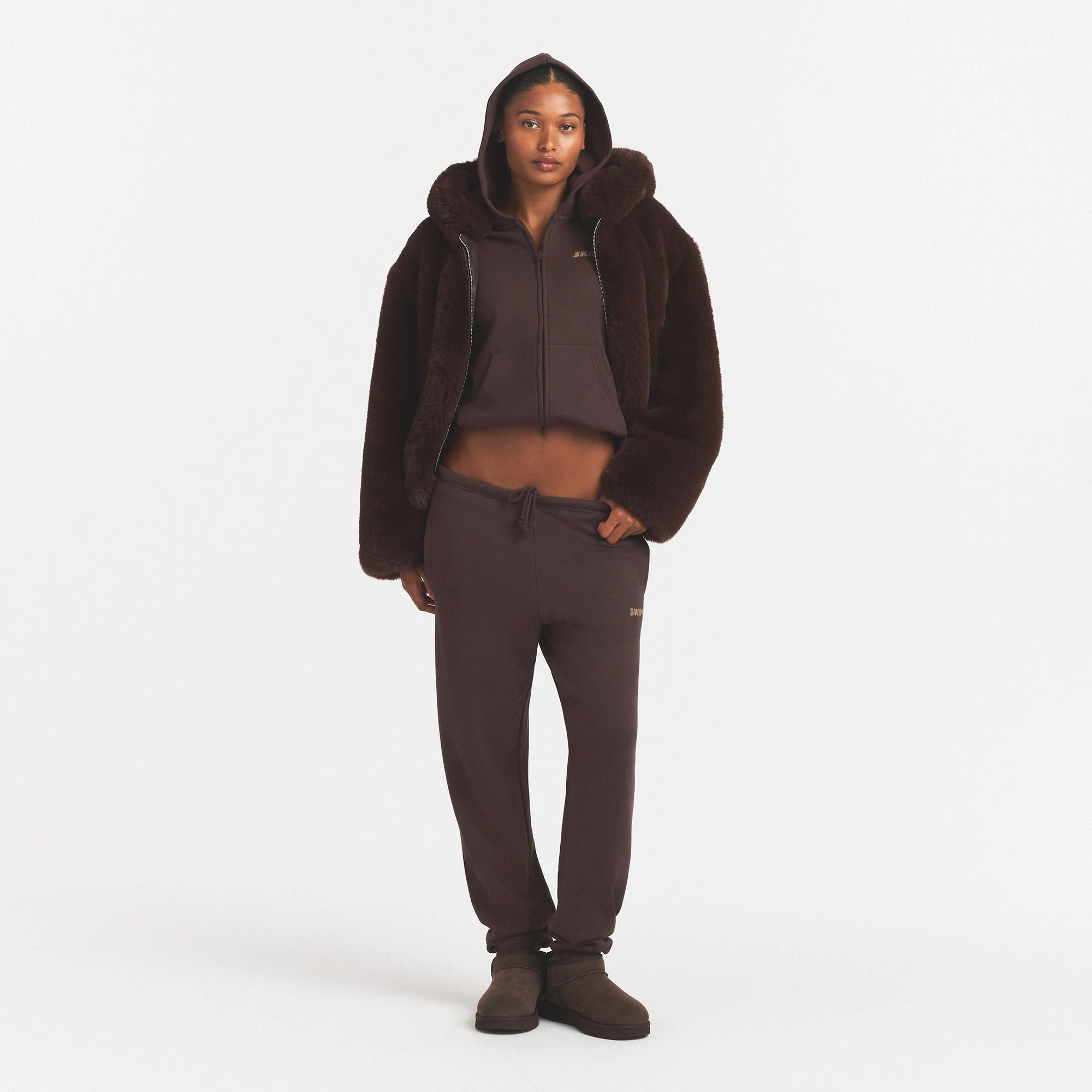 FAUX FUR HOODED JACKET | COCOA & LAYS FLAT ON A WHITE BACKGROUND | FLT @ | FOCUS: 0.0, 1.0, 0.9