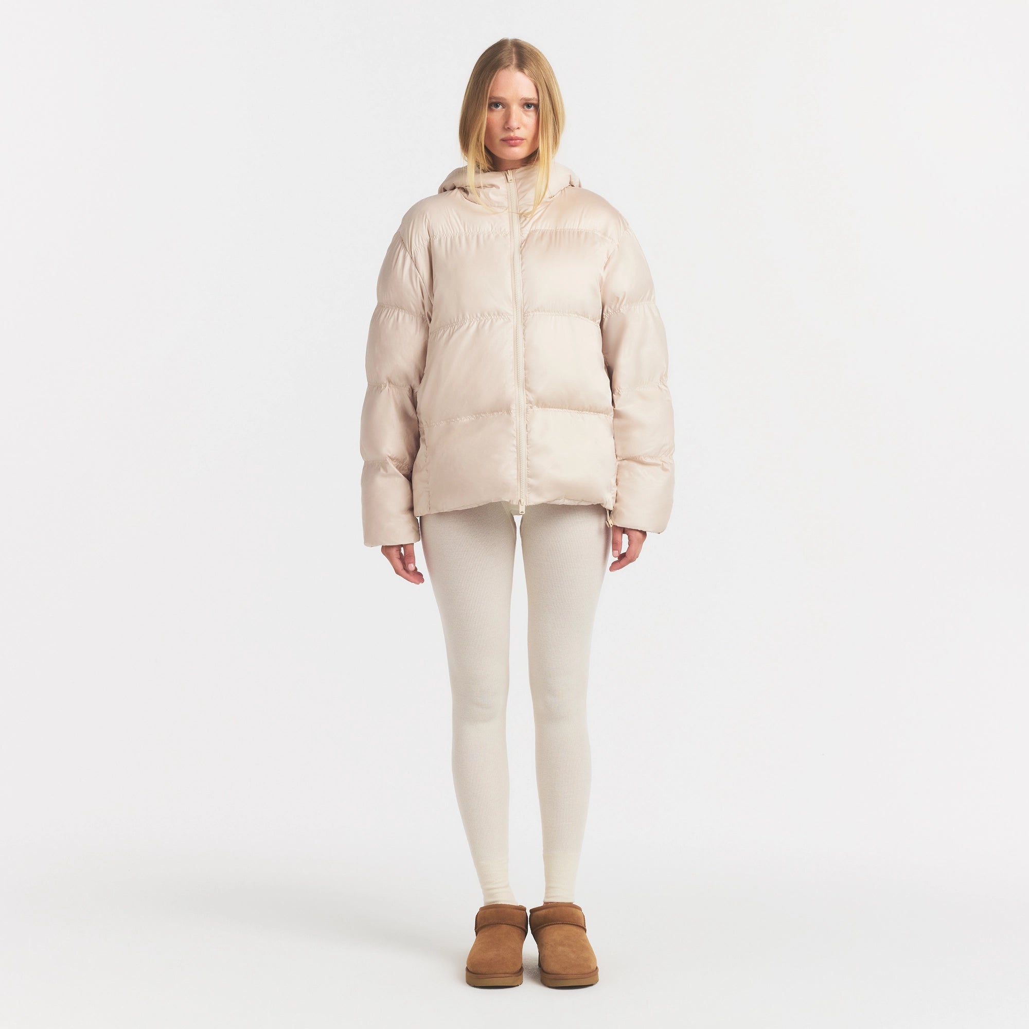 SKIMS PUFFER HOODED JACKET | CHAMPAGNE ON A MODEL FRONT VIEW @ | FOCUS: 0.0, 1.0, 0.9