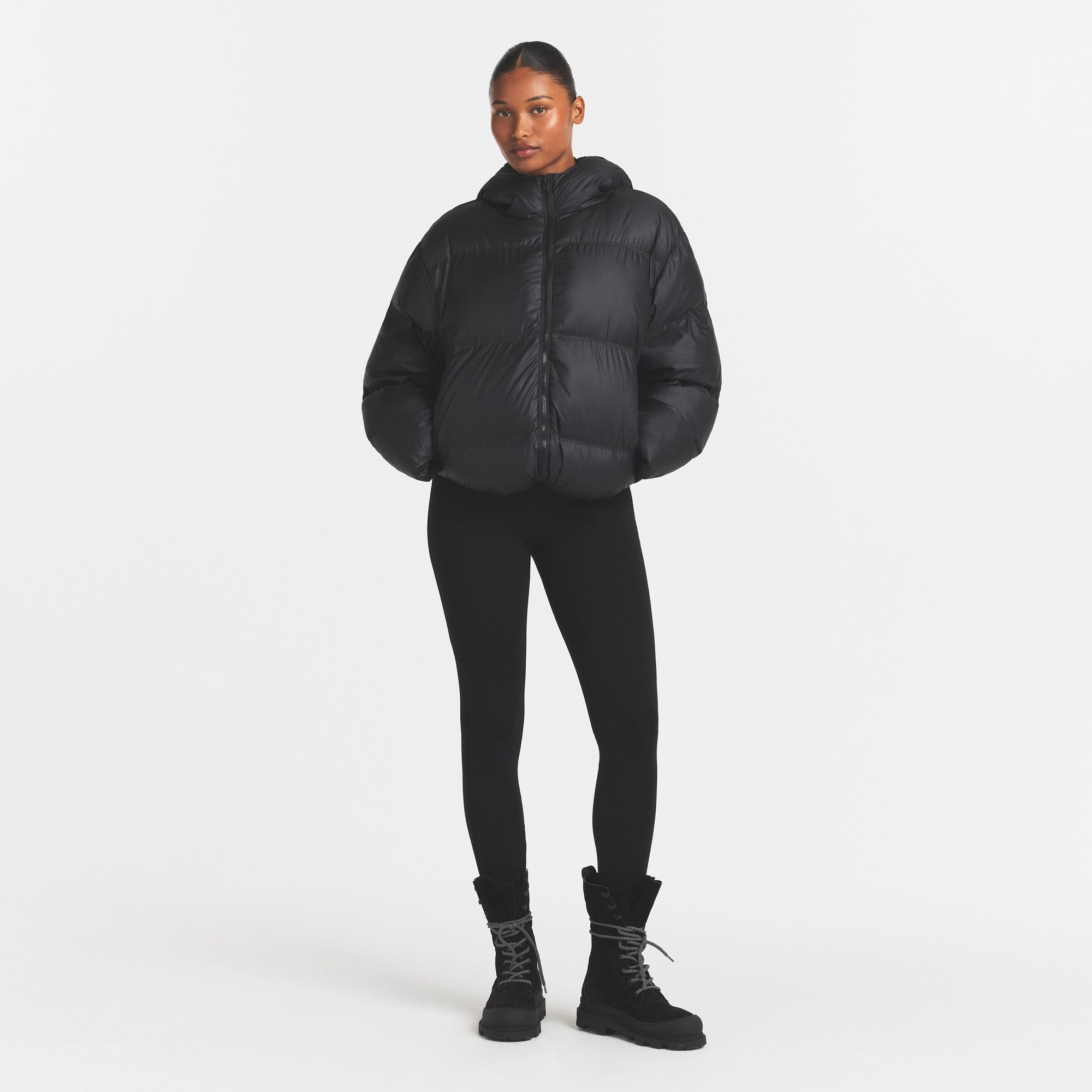 SKIMS PUFFER HOODED JACKET | ONYX ON A MODEL FRONT VIEW @ | FOCUS: 0.0, 1.0, 0.9