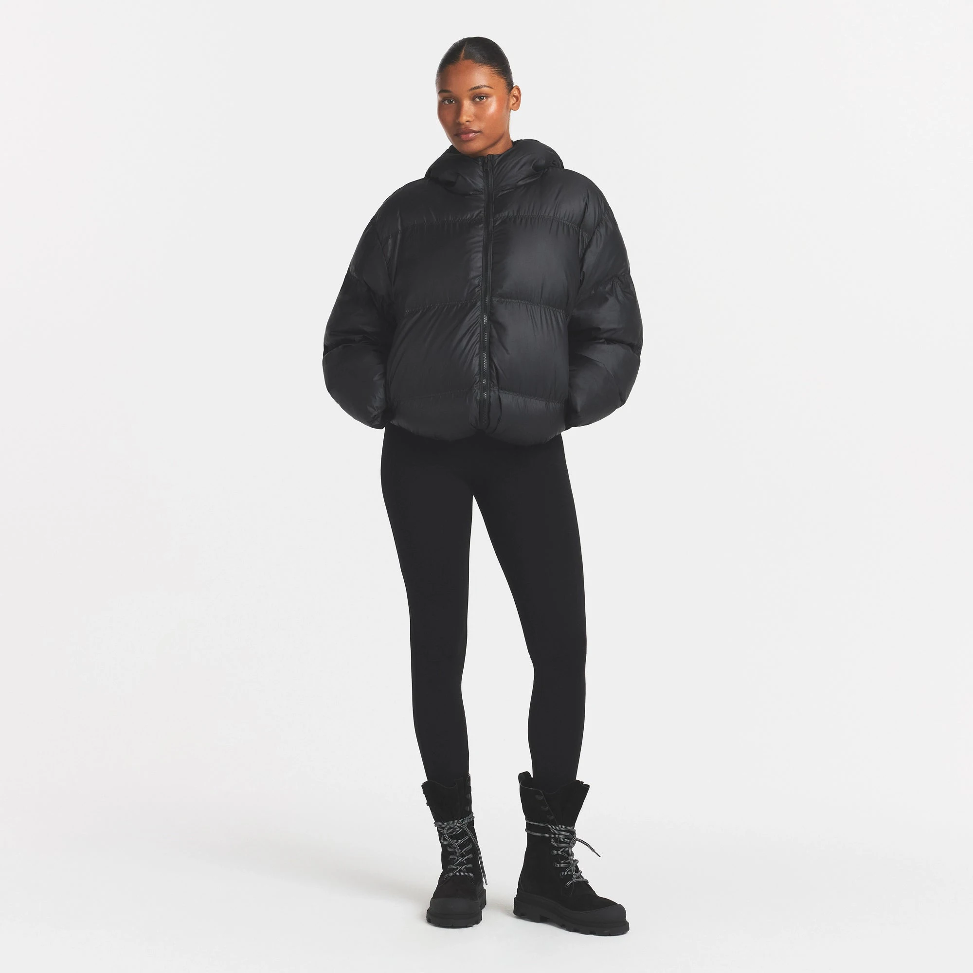 SKIMS PUFFER HOODED JACKET | ONYX ON A MODEL FRONT VIEW @ | FOCUS: 0.0, 1.0, 0.9