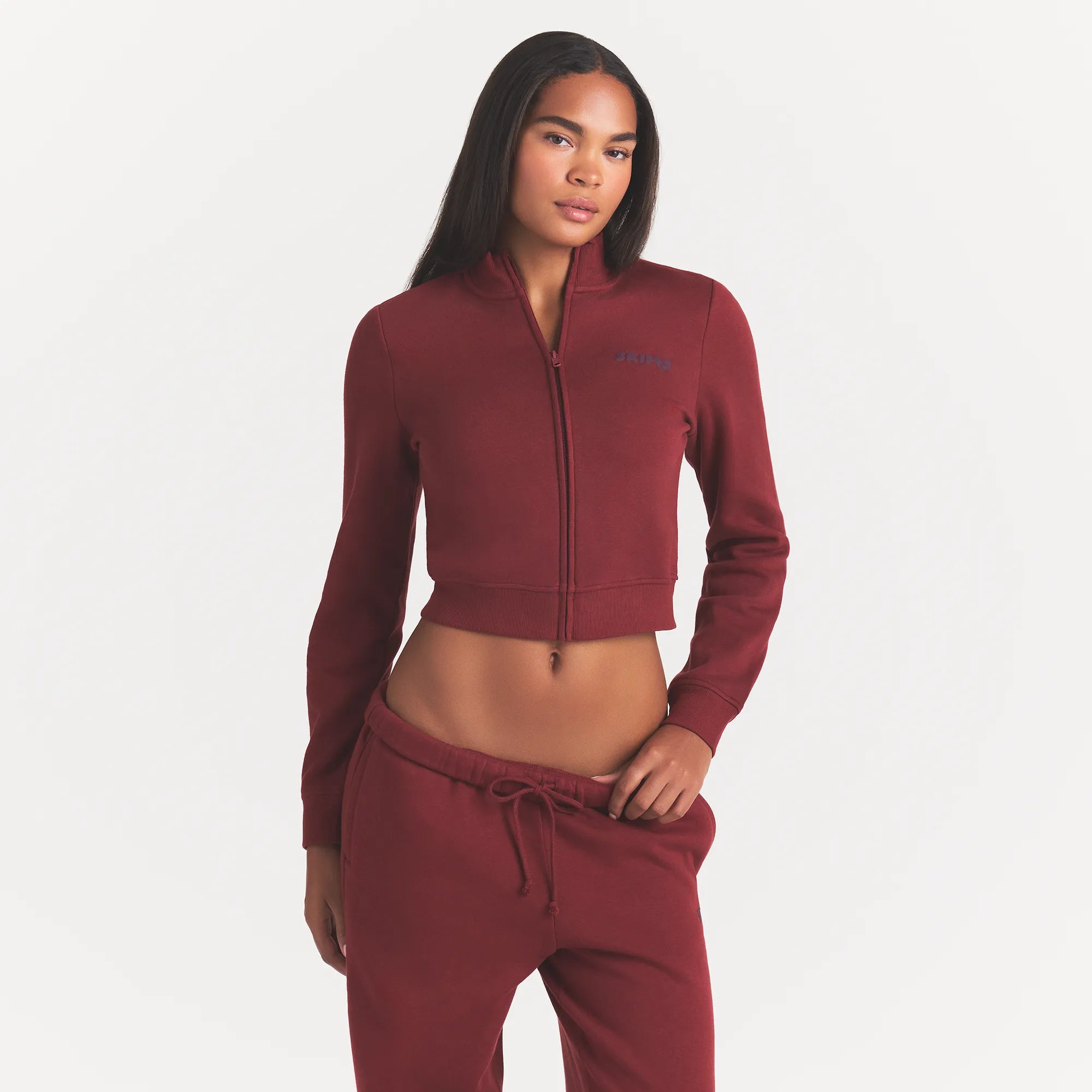 COTTON FLEECE LOGO TRACK JACKET | MERLOT ON A MODEL FRONT VIEW @ | FOCUS: 0.0, 1.0, 0.9