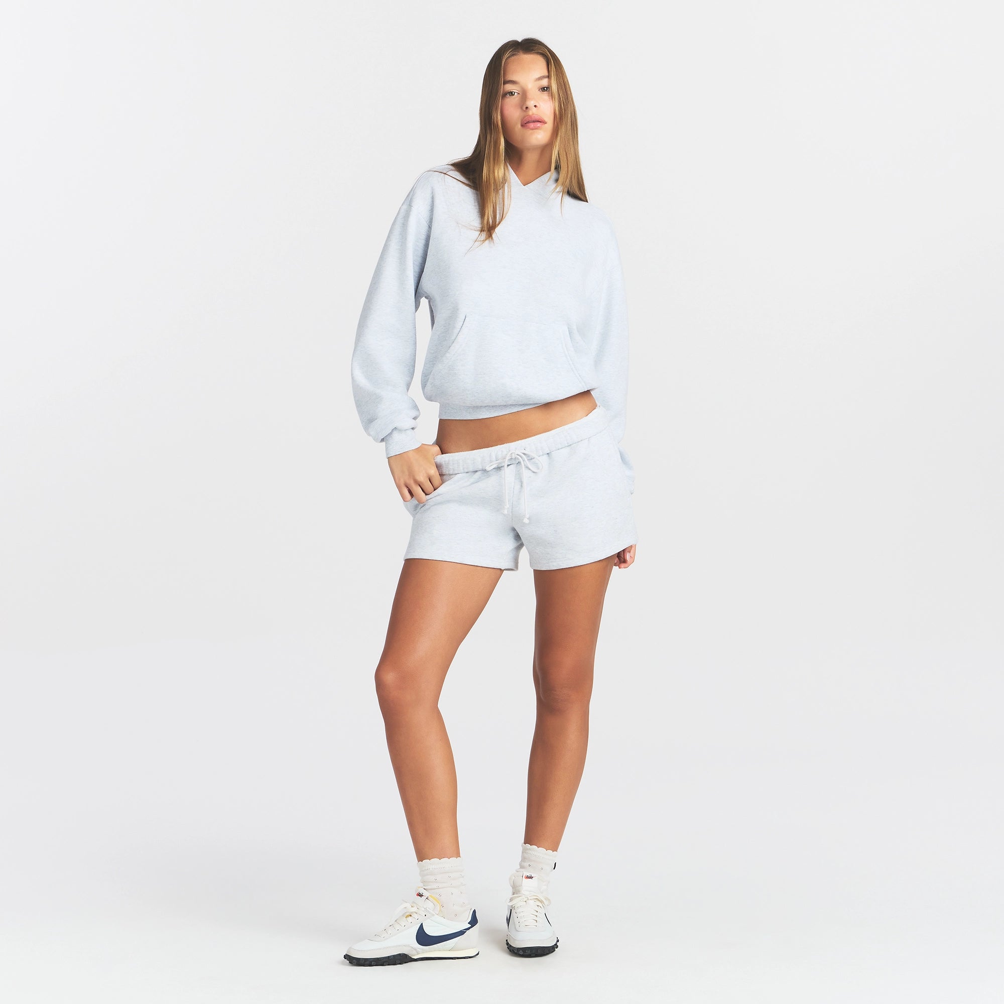 COTTON FLEECE CLASSIC HOODIE | LIGHT HEATHER GREY ON A MODEL FRONT VIEW @ | FOCUS: 0.0, 1.0, 0.9