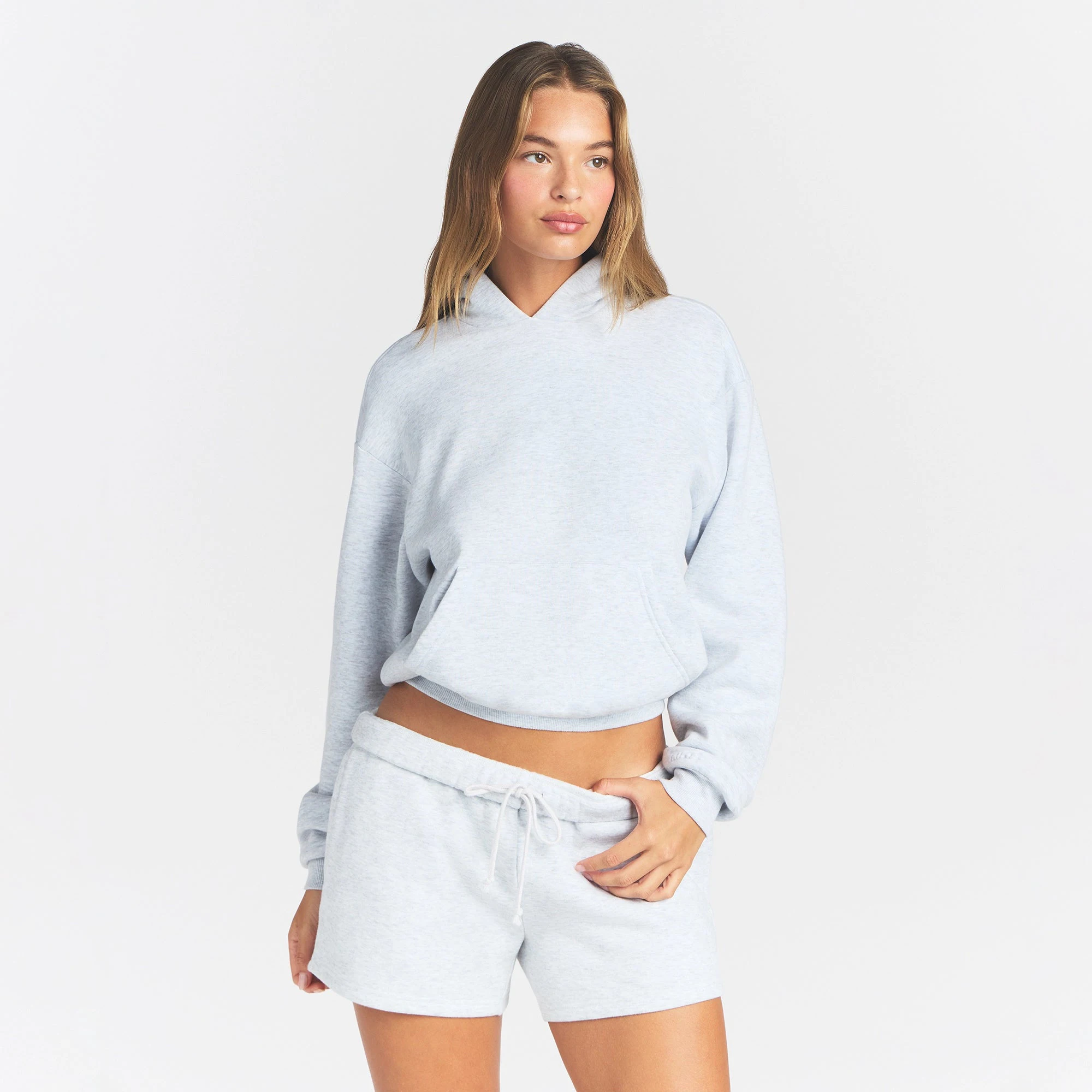 COTTON FLEECE CLASSIC HOODIE | LIGHT HEATHER GREY ON A MODEL FRONT VIEW @ | FOCUS: 0.0, 1.0, 0.9