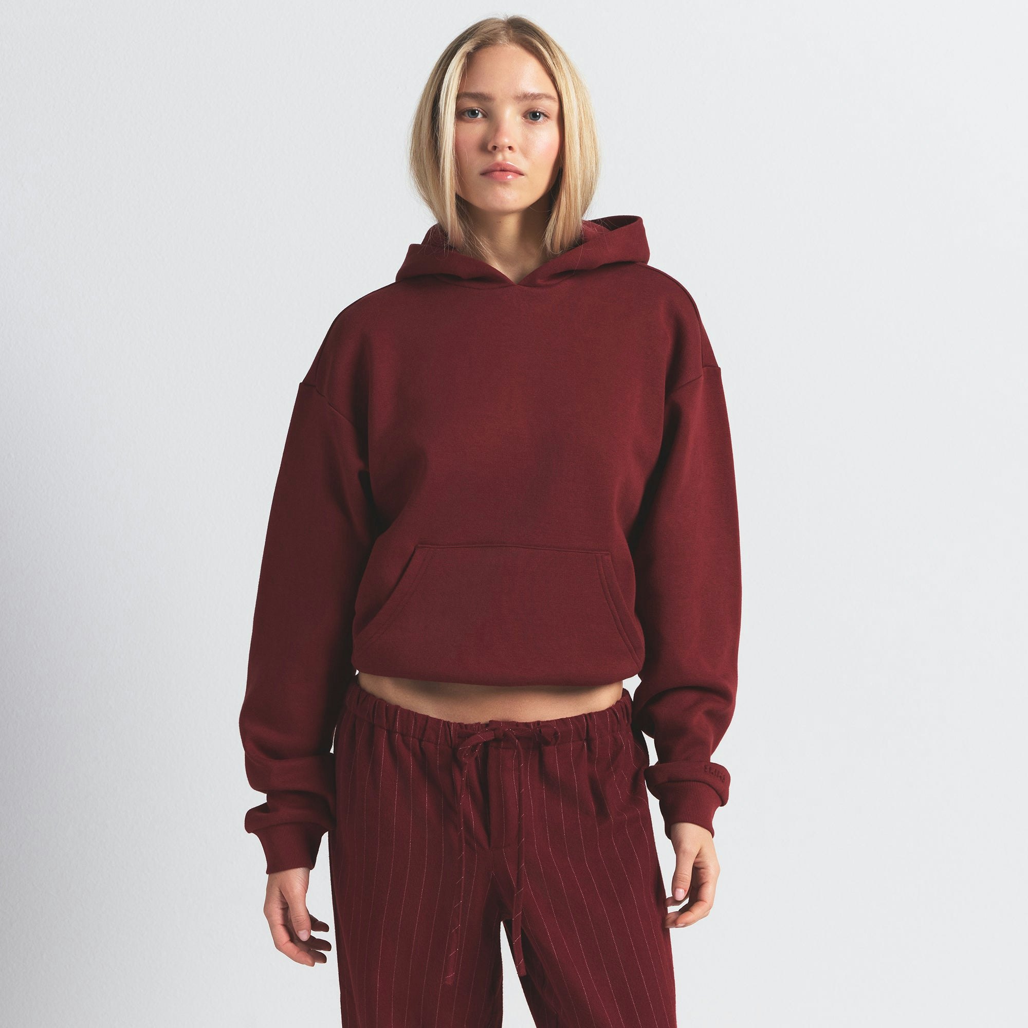 COTTON FLEECE CLASSIC HOODIE | MERLOT ON A MODEL FRONT VIEW @ | FOCUS: 0.0, 1.0, 0.9