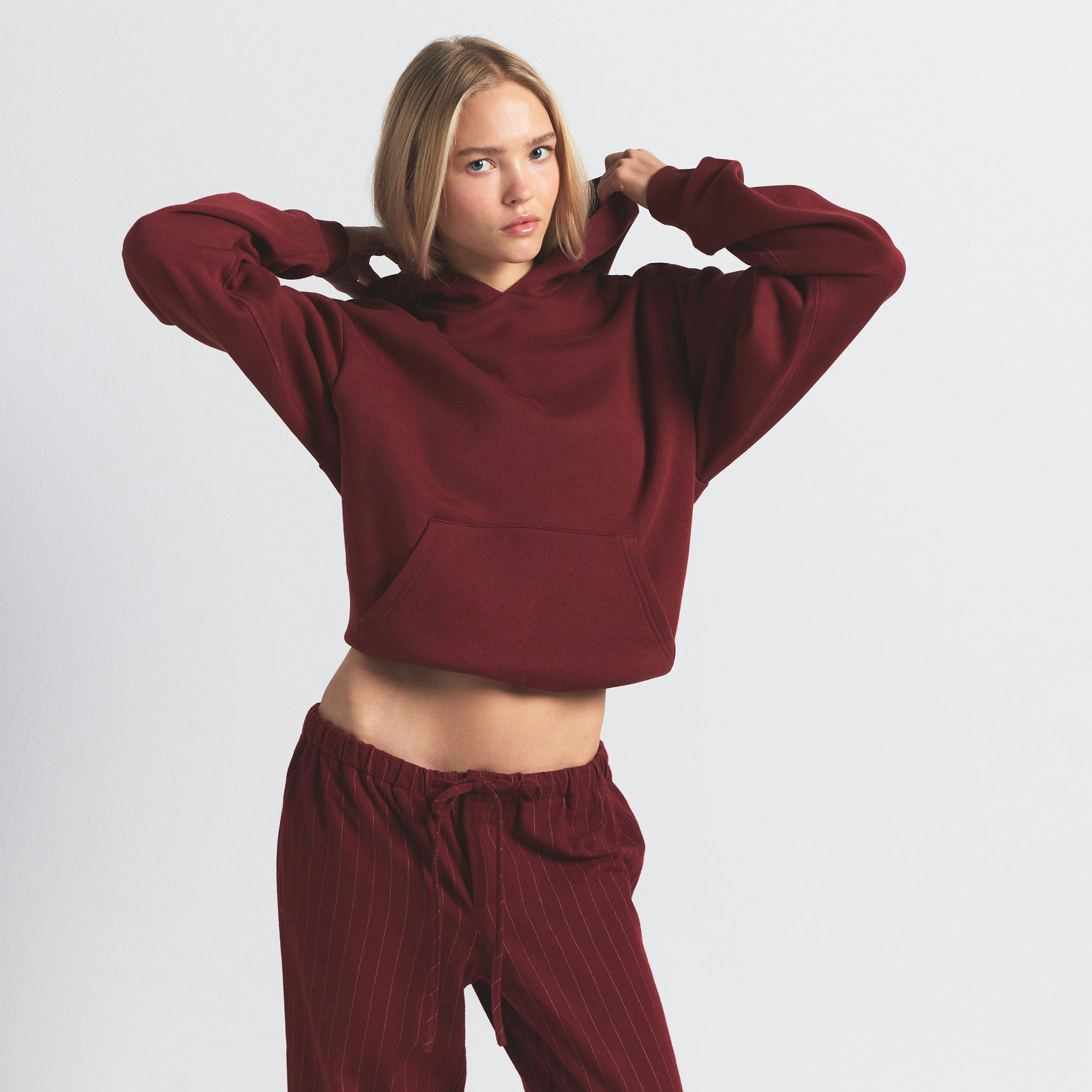 COTTON FLEECE CLASSIC HOODIE | MERLOT ON A MODEL FRONT VIEW @ | FOCUS: 0.0, 1.0, 0.9