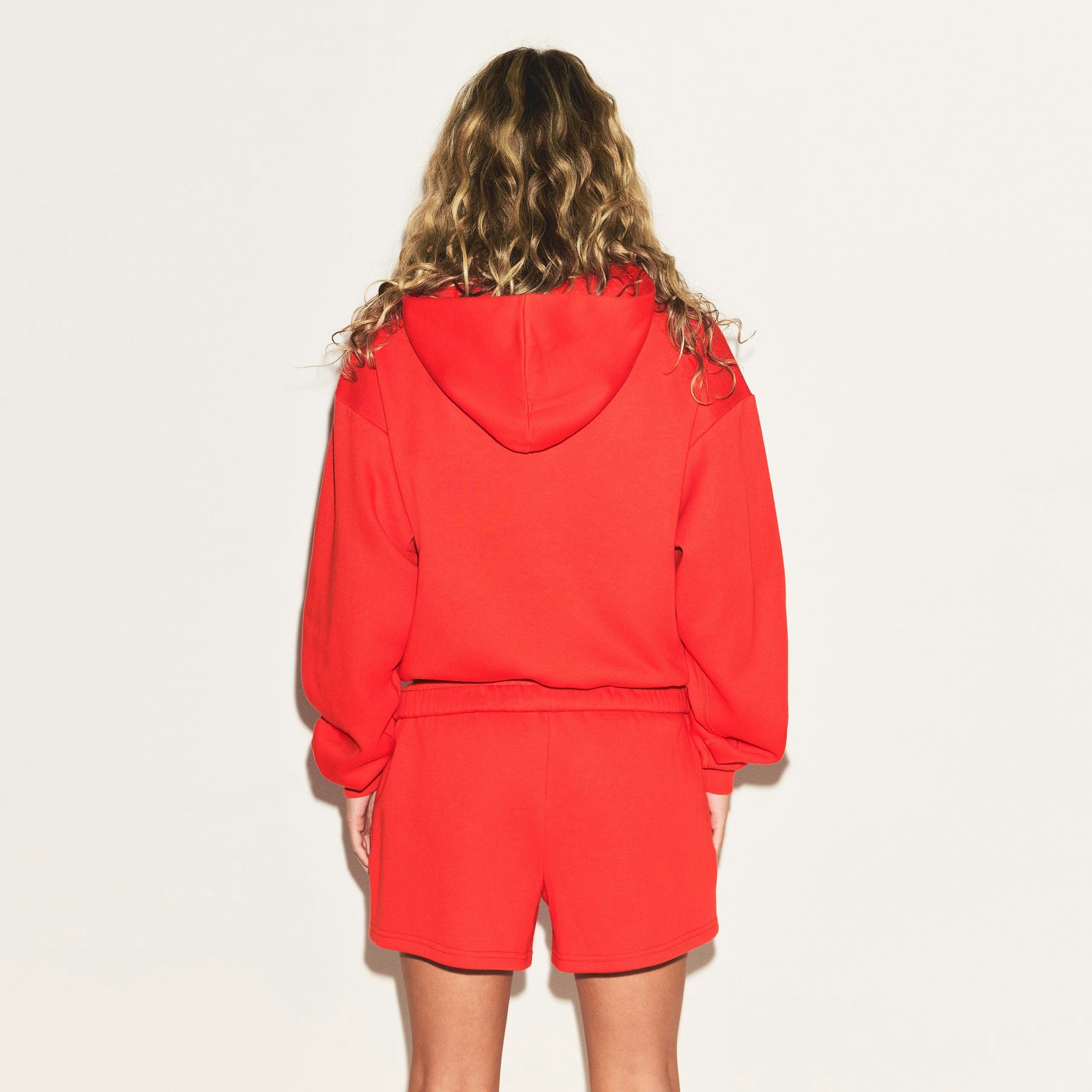 COTTON FLEECE CLASSIC HOODIE | RUBY ON A MODEL SIDE VIEW | FOCUS: 0.0, 1.0, 0.9