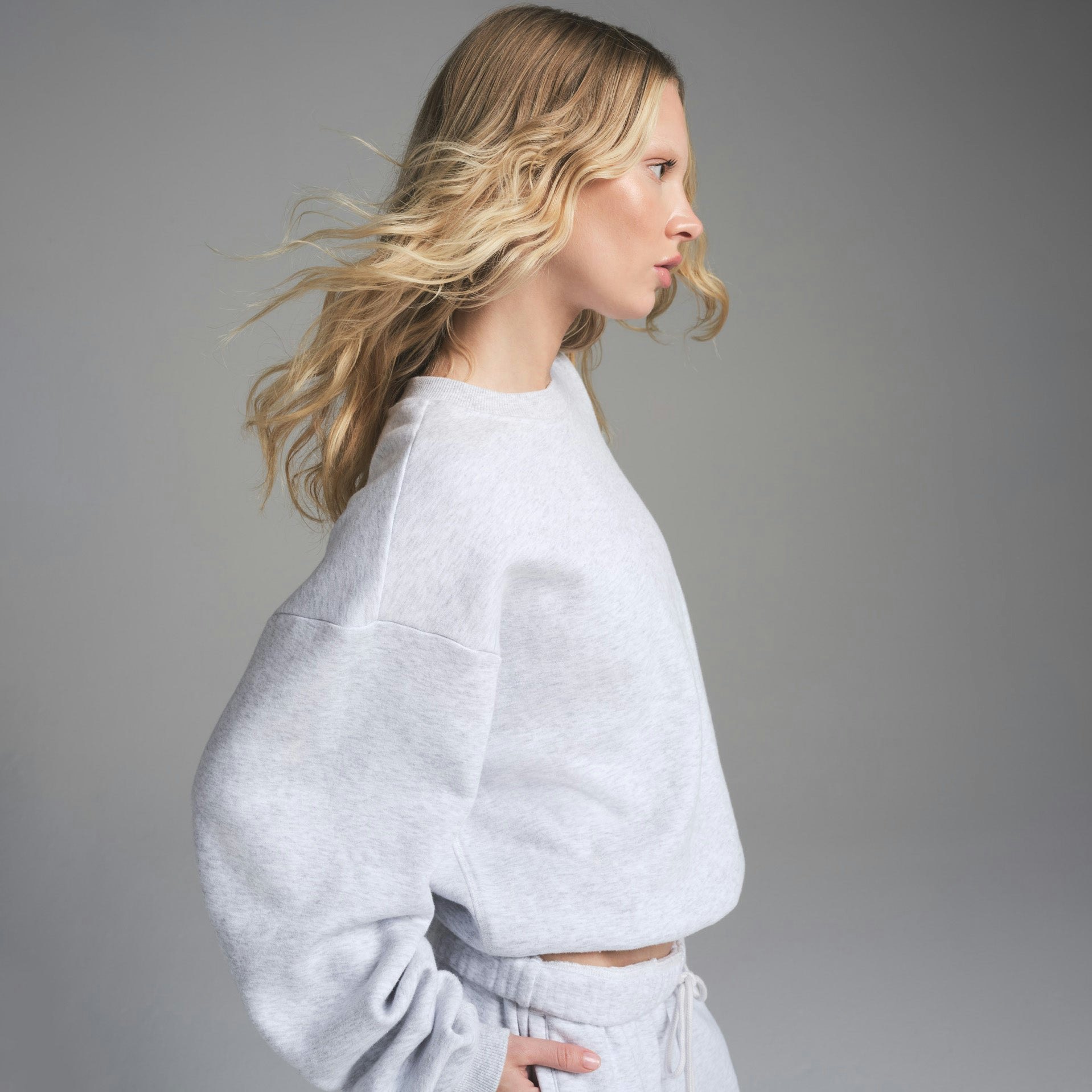 COTTON FLEECE CLASSIC CREWNECK | LIGHT HEATHER GREY ON A MODEL FRONT VIEW | FOCUS: 0.0, 1.0, 0.9