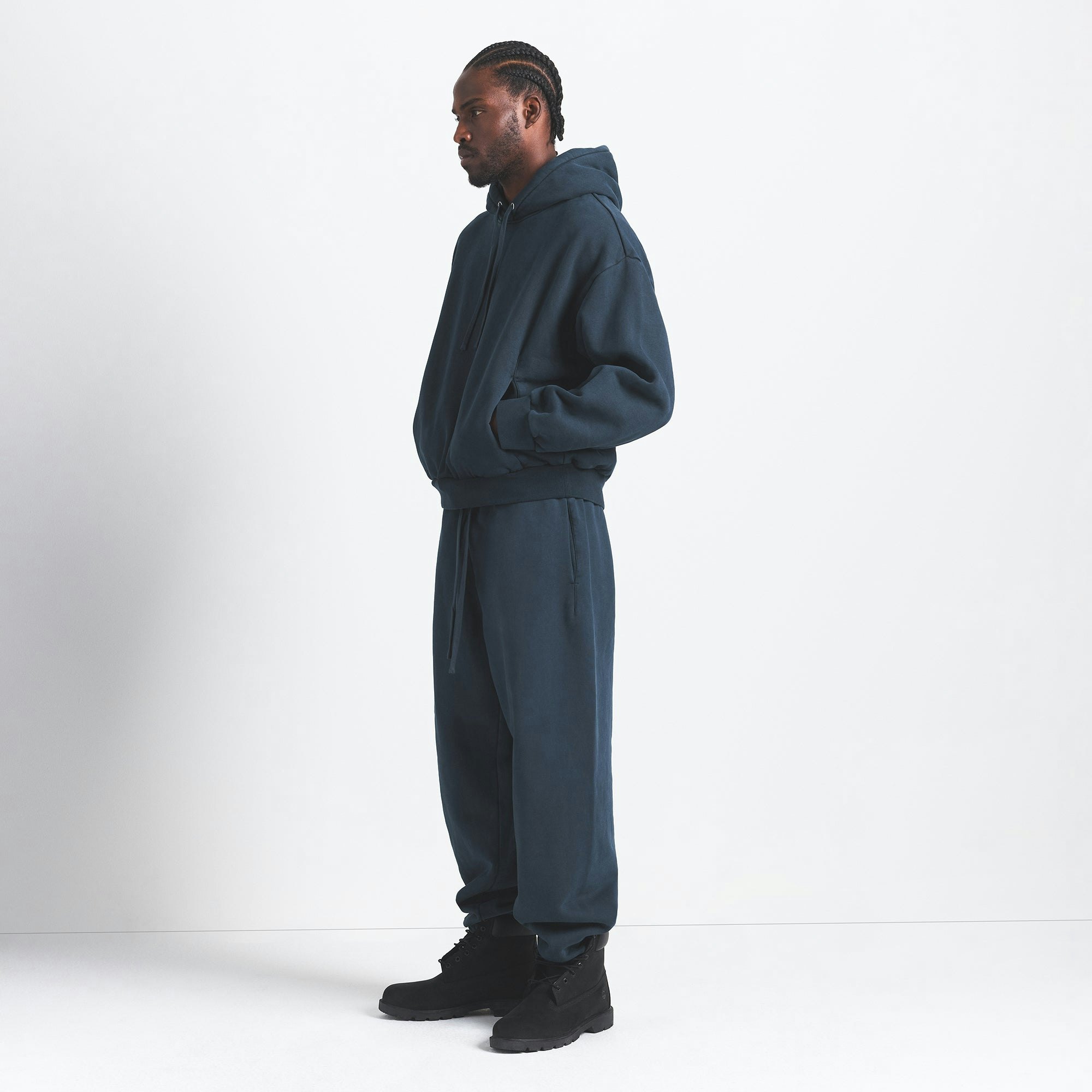 HEAVYWEIGHT FLEECE MENS HOODIE | NAVY ON A MODEL SIDE VIEW @ | FOCUS: 0.0, 1.0, 0.9