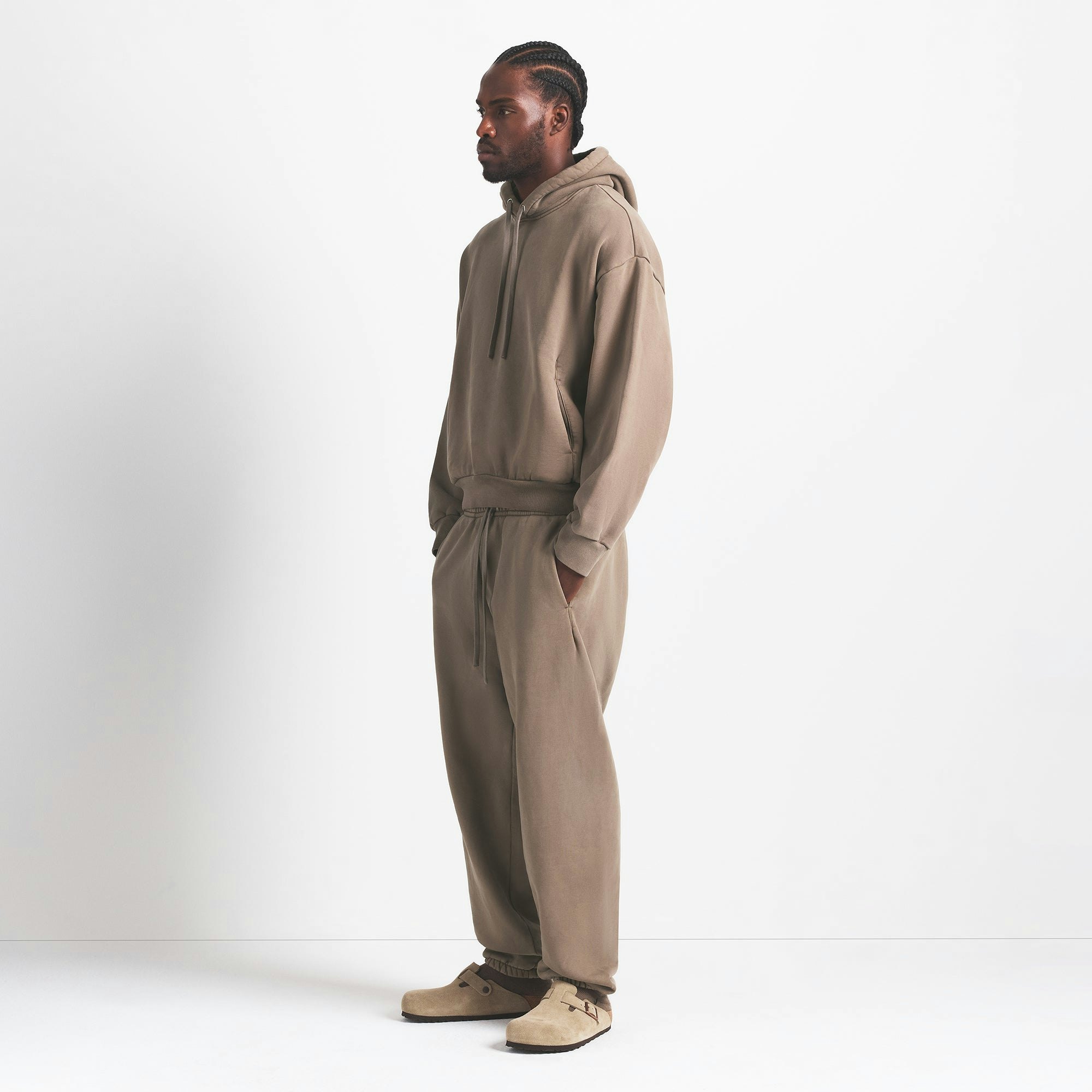 HEAVYWEIGHT FLEECE MENS HOODIE | TRUFFLE ON A MODEL SIDE VIEW @ | FOCUS: 0.0, 1.0, 0.9