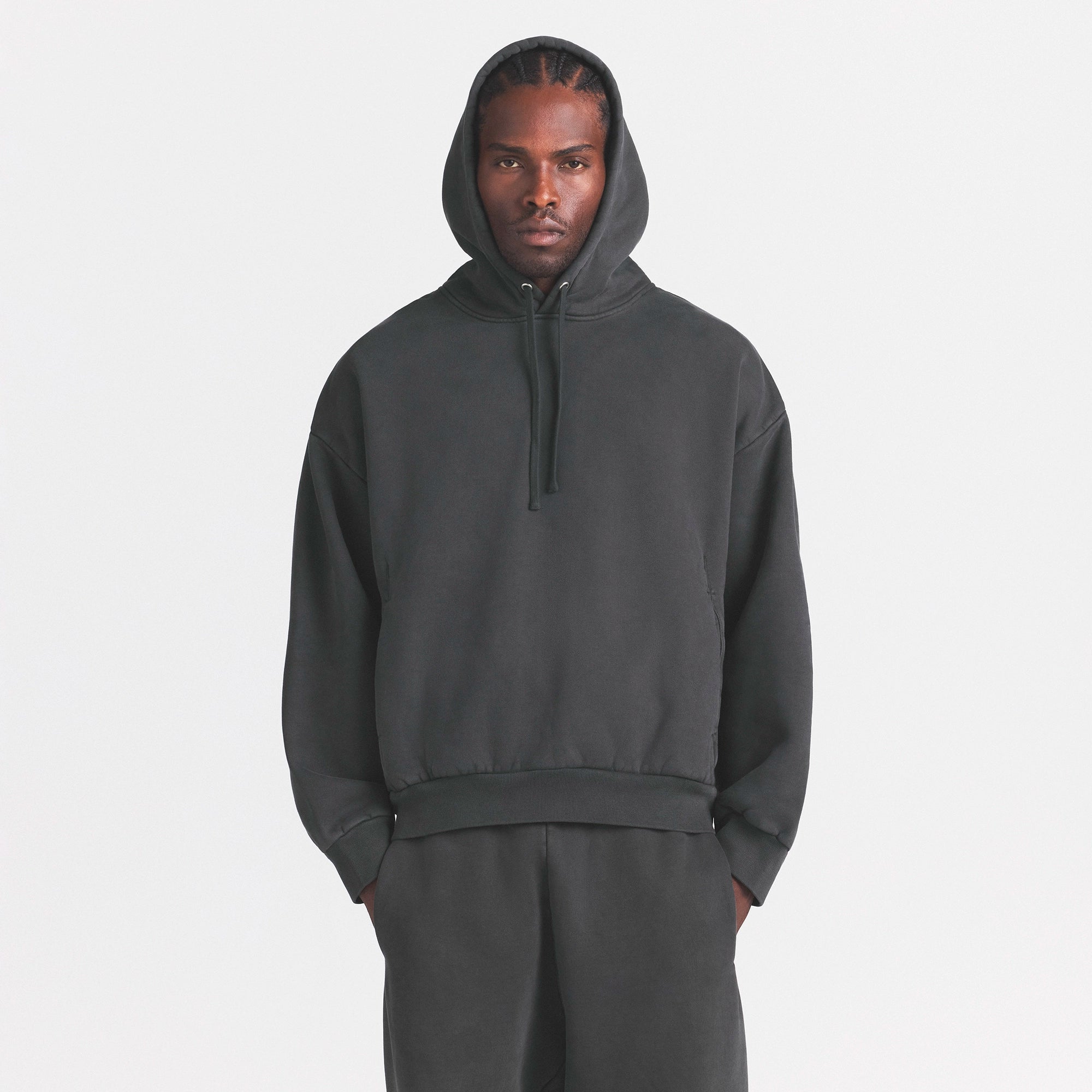HEAVYWEIGHT FLEECE MENS HOODIE | WASHED ONYX ON A MODEL SIDE VIEW