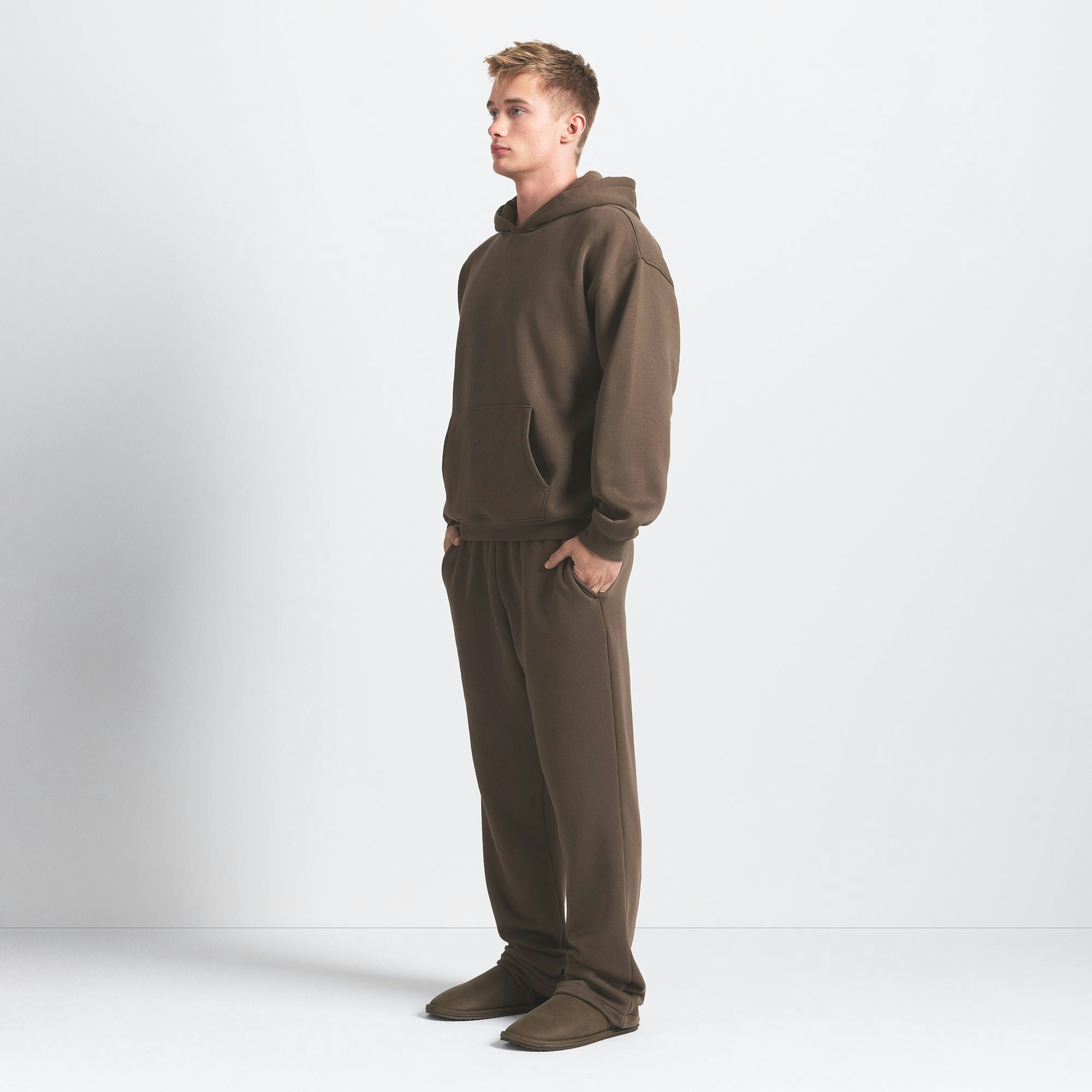 FLEECE LOUNGE MENS RELAXED HOODIE | DRIFTWOOD ON A MODEL SIDE VIEW @ | FOCUS: 0.0, 1.0, 0.9